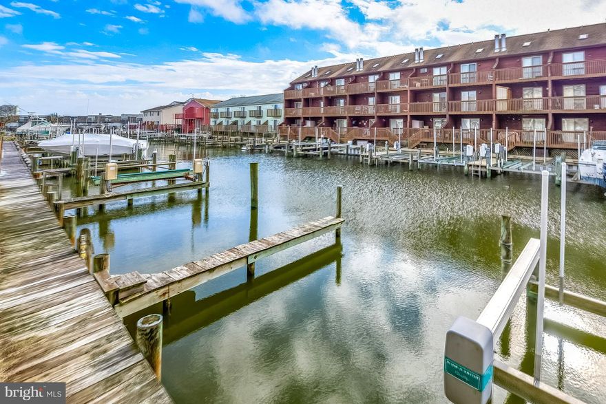 MOTIVATED SELLER BRING ALL REASONABLE OFFERS!! PRICED TO SELL FAST!!!  Large waterfront 3BR/2.5BA townhome with  boat slip and lift in ideal location.  This is a premier unit and is being sold fully furnished turnkey for your immediate enjoyment.  The beautiful kitchen will be sure to delight any cook with plenty of cabinet space and large countertops to prepare family meals. There is a dining area to enjoy family dinners off the kitchen. The large living area opens to an oversized deck for entertaining with friends. The large master bedroom overlooks the water and has a wonderful deck for you to enjoy summer breezes. There are two additional bedrooms for friends and family and there is also a large storage area.  This townhome is close to the boardwalk, shops and restaurants.  Come take a look today!