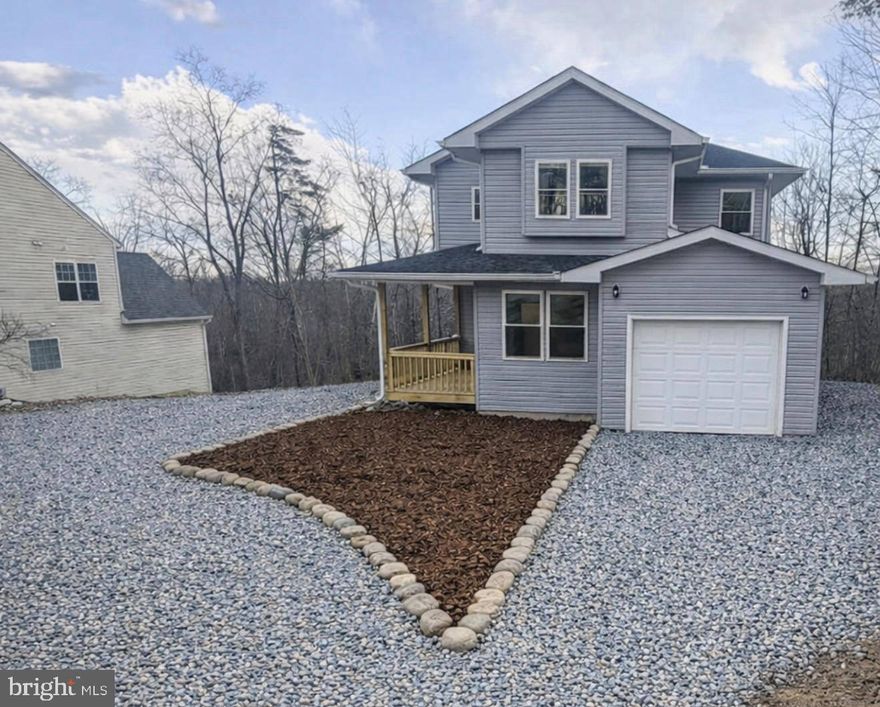 Brand-new construction at 607 South Lakeview Dr. offers a perfect blend of modern comfort, thoughtful design, and scenic surroundings. Construction is complete—this home is truly turnkey and move-in ready.
Step inside to discover a desirable open floor plan designed for both comfortable living and effortless entertaining. The main level features a beautifully connected living space where the kitchen flows seamlessly into the family room with a fireplace and the bright morning room, creating an inviting gathering area for everyday living.

From the family room, step directly onto the deck overlooking a peaceful view of the trees, offering the perfect setting for morning coffee, outdoor dining, or simply enjoying the natural surroundings.

The kitchen is a chef’s delight, featuring granite countertops, stainless steel appliances, ample cabinetry, and a spacious pantry for additional storage. Luxury vinyl flooring throughout the main living areas and bathrooms adds style and durability, while plush carpeting in the bedrooms provides a cozy touch.
Upstairs, the spacious primary suite is thoughtfully positioned on one side of the home, creating privacy, while two additional bedrooms are located on the opposite side.

The full unfinished walkout basement with high ceilings offers endless possibilities for customization and already includes rough-in plumbing for a future full bath.

Additional highlights include a long private driveway and a one-car garage, providing convenient parking and storage.

With new construction completed and ready for its first owners, this home offers modern finishes, functional design, and peaceful wooded views—all in a move-in ready package.

Living in Lake Holiday Estates means access to an array of exceptional amenities, including:  
- A stunning 240-acre lake for boating, fishing, swimming, and kayaking.  
- Sandy beaches and designated swimming areas.  
- A clubhouse perfect for social gatherings and events.  
- Tennis, pickleball, and basketball courts for active lifestyles.  
- Scenic walking trails and a dog park for outdoor enthusiasts.  
- 24/7 gated security for peace of mind.