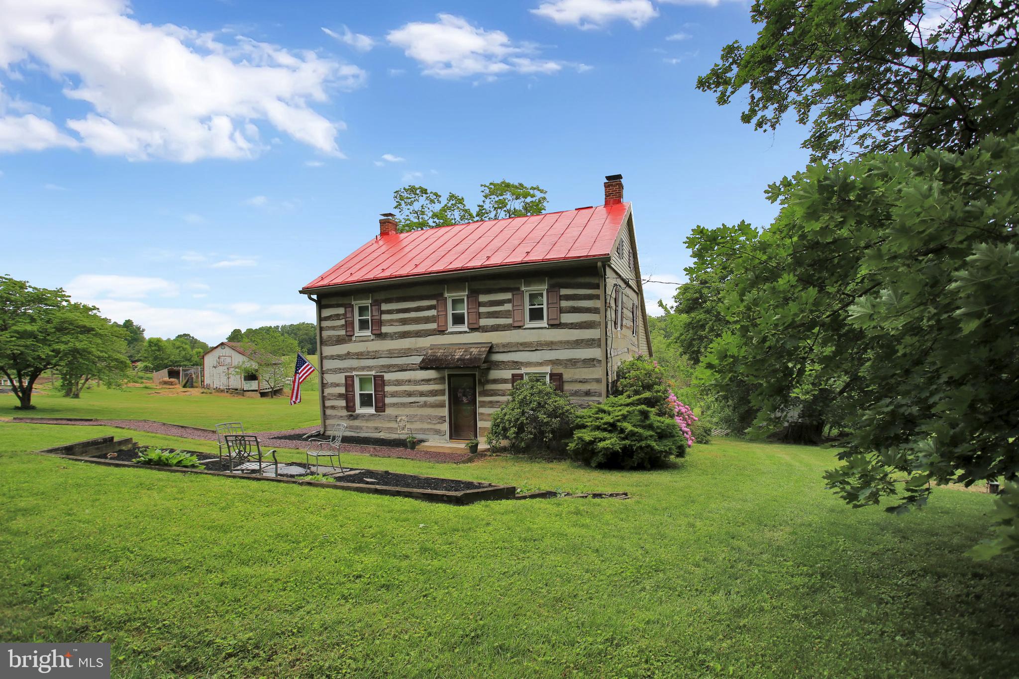 This carefully restored charming log home sits on 18+ acres and is a rare find. You will love the original features that truly compliment the modern touches. This 4 bedroom home offers 2 full baths, Random width wood floors, beautifully exposed log beams, newer windows, 2 Fireplaces, spacious eat-in kitchen. Family room with a great loft. Step outside and be amazed by the peaceful nature and the private setting. A carriage house with electricity, chicken coop for all your chickens that could produce your own organic eggs, 2 fenced pastures, 10 acres in Hay, 2 wooded acres, several fruit trees and so much more. 40 X 70 Barn features water and electricity and has 5 stalls with room for a few more if required, upper hay, and storage loft. Bring your horses and all your livestock animals and truly enjoy this paradise. "Great Hunting Spot" as well!!!!
