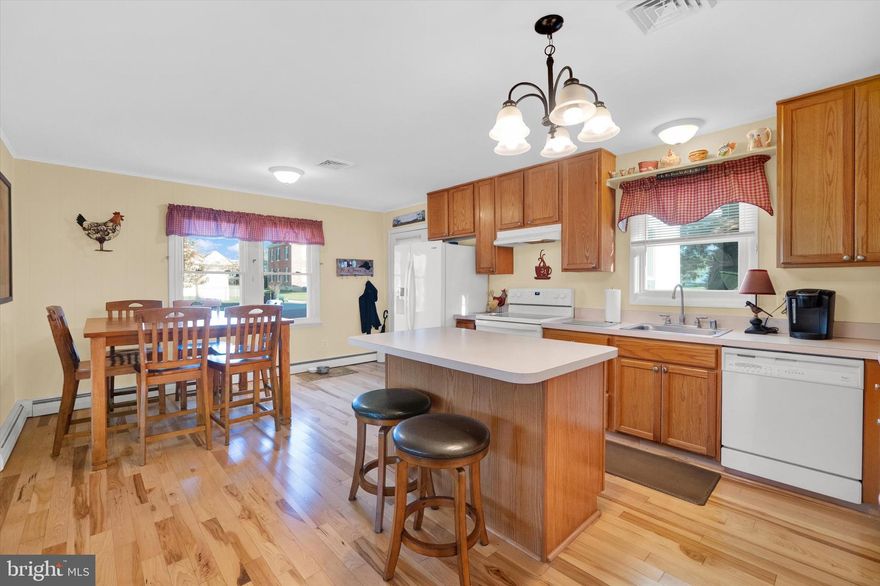 Offer Deadline Monday 11/20 at Noon. Easy One floor living with a picture perfect yard and picket fence.   Owners have made this one cozy and cute from the Mudroom Entry to the Lower Level Full Bath and possible 3rd Bedroom .  Arrive home to your  freshly paved double wide drive, enjoy the sunset over your front lawn of green grass and your own American Dream picket fence. The enclosed/porch  functions as entry foyer and mudroom  providing a space for all the things.  A spacious kitchen  with ample wood  cabinetry and a pantry provides plenty of room for the chef.  They have 10-12 for family dinner with no problem in this open floor plan. Enjoy seamless wood flooring through out the first level living areas. Two spacious bedrooms with carpet and a full bath finish the main floor.  Your American Dream even has a fire place ! Another family room is available downstairs', along with a  full bath and another finished room with a closet.  There is an exit door with stairs to the back yard through the Utility Room. Extra storage, laundry and outside access in the remaining space.   When you tour this home you will see how the sellers have loved and cared for this home and made it special .  It is ready for the next chapter with  an  updated the roof, windows, appliances and HVAC.   Book your tour today.