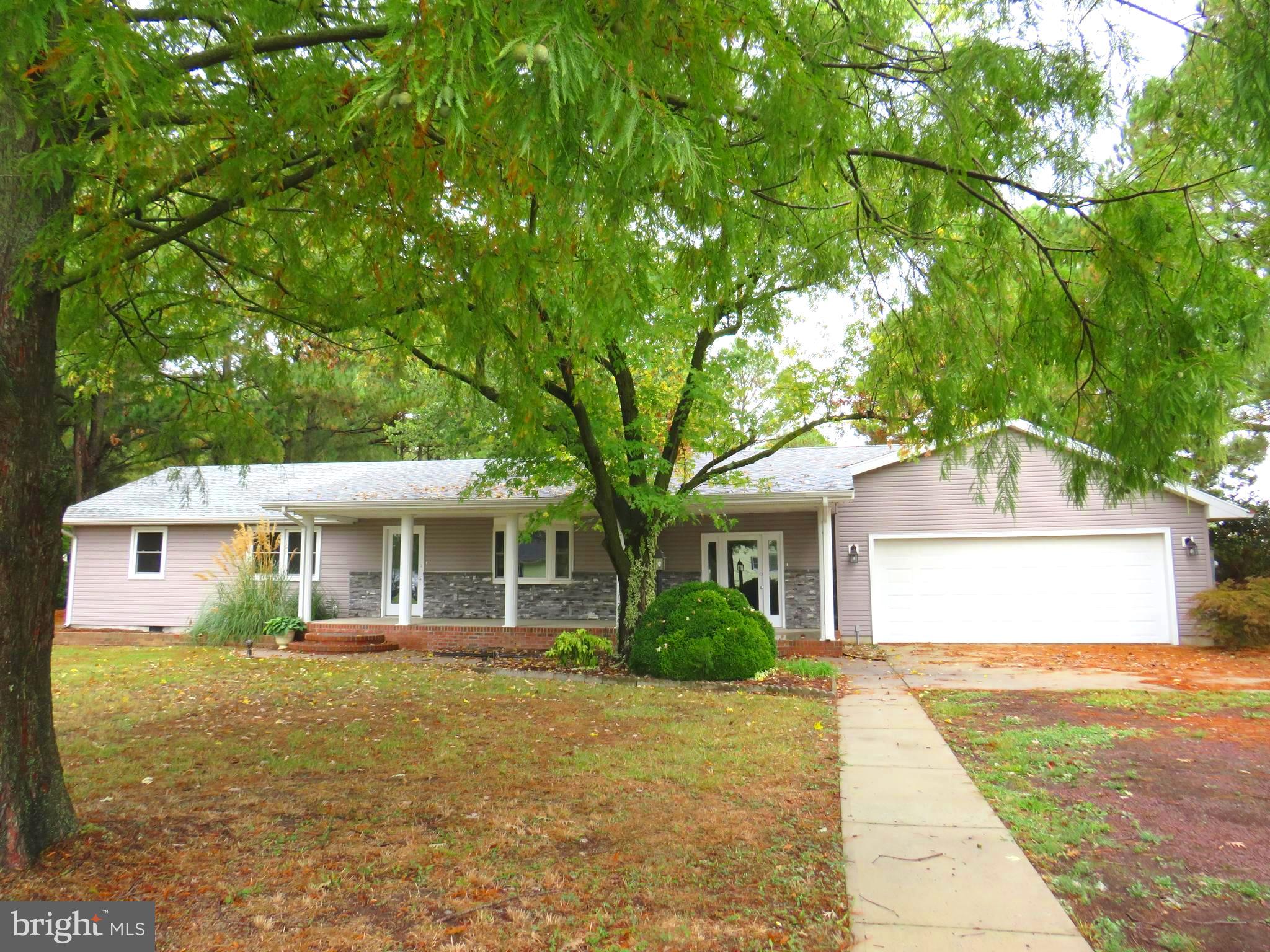 This house gives mid century modern feels with the open front porch, stacked stone trim and low profile design. Inside the home has been completely renovated to suit modern aesthetic. LVP flooring, gorgeous kitchen with granite countertops, stainless appliances, soft close cabinetry, and a center island. Open floor plan flows into the living room with a fireplace. This home is perfect for entertaining! Four bedrooms, three baths, primary bedroom has access to deck at rear of home, primary bath has custom tiled shower with rain showerhead feature, and a double vanity. Additional two full bathrooms have tiled flooring and tub/shower combination. Dock space for two boats, deep water canal with easy access to Jones Creek and the Annemessex River for boating and great fishing. Attached two car garage. with paved driveway. Additional photos to be posted soon!