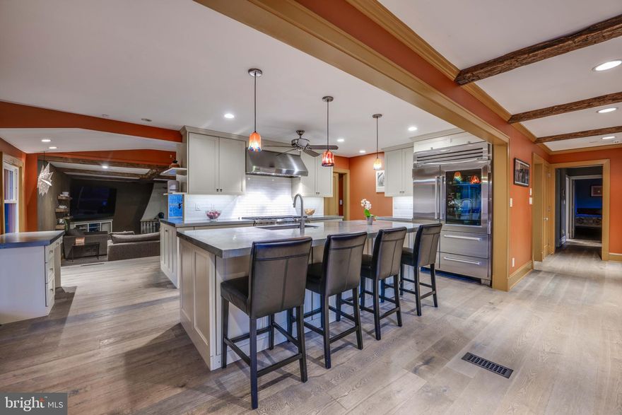 Live authentically. Delbert Adams’ vision comes to life with this reimagined rancher in coveted Sparks. A unique blend of sophistication and comfort, this fully renovated gem is a true getaway and delight to the senses. Seamless open floor living spaces for modern day living. Exquisite chef’s kitchen with zinc countertops, Wolf range, Subzero fridge, coffee bar, pantry and more. While relaxing by the new wood burning stove, the large glass expanse in the family room beckons you to the outdoors . With decorative woodwork and beautiful hardwoods, no detail was overlooked. Luxurious baths. Bedroom cabinetry and closets done by California closets. Watch the landscape’s colors change with the seasons in the screened-in porch, back deck or hot tub. Fill your summer days with fun while swimming in the heated salt water pool. The expansive outdoor kitchen is an entertainer’s dream. The ultimate oasis. Bring your animals and utilize the barn and solar-powered electrified pasture fencing. A swanky carport with EV chargers. Whole house generator also services pool, EV and hot tub. A timeless masterpiece for all ages. Retreat starts here. The art of uniting human and home.