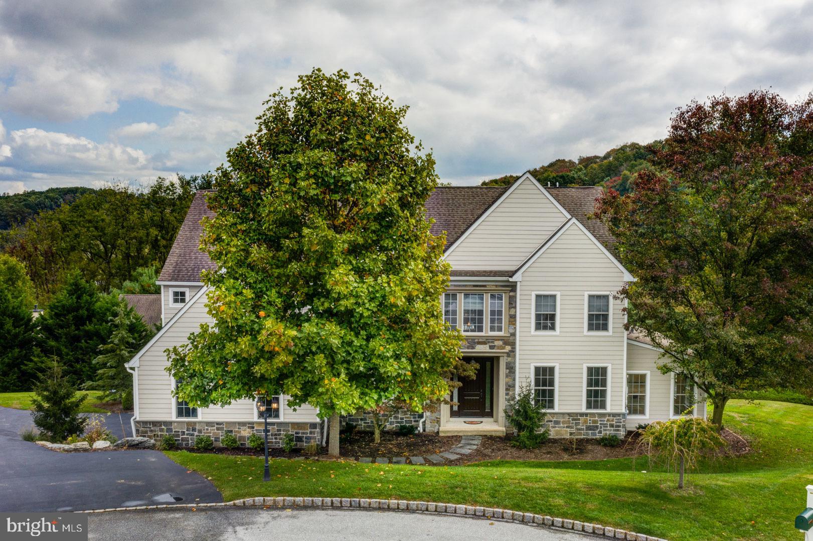 Welcome to this gorgeous, immaculately maintained home with stunning views in the desirable community of Tattersall! Located on a cul-de-sac, this elegant home provides the perfect combination of privacy and neighborhood living. The impressive exterior boasts new hardie plank siding, stone accents, and a grand 8-ft entrance door. Guests and family are welcomed into the gracious foyer and immediately appreciate the stately 3-story staircase, beautiful hardwood floors, and stunning architectural details. The formal living and dining rooms are enhanced with arched entryways and handsome crown molding and wainscoting. French doors from the living room and private office lead to a large, sun-drenched conservatory with sylvan views. The informal living spaces are phenomenal, featuring a huge family room with 20+ ft vaulted, beamed ceiling, blue stone fireplace and columns, and a wall of windows showcasing the breathtaking views. The open floor plan includes a gourmet kitchen with cherry cabinetry, granite counters, and high-end stainless appliances. A bright breakfast room opens to a large, low-maintenance deck, perfect for enjoying a morning cup of coffee with the rising sun. Two staircases lead to the 2nd floor, highlighted by the spacious master suite with intimate sitting room, crown molding, dual walk-in closets, and sumptuous private bath with natural stone – the perfect place to unwind after a long day. Two generously sized guest bedrooms, one with a bonus sitting room/office, share a bath while the 4th bedroom enjoys an en-suite bath. The incredible 3rd floor, with 1000 sq ft of finished living space, features hardwood floors, exposed beams, a 5th bedroom with private bath, and (for melting away the stress of working or teaching from home) an infrared cedar sauna! Perfect for a guest suite, virtual classroom, or 2nd office, this space is limited only by your imagination. For relaxation and entertainment, head to the fully finished, walk-out basement. Watch a movie, get in a good work-out, or gather around the built-in bar to cheer on your favorite team. During the warmer months, the party can spill out onto the beautiful paver patio, featuring curved walls, multiple seating/dining areas, post lights, and a granite fire pit. This spectacular home is conveniently located in the award-winning Downingtown School District, and is just minutes from the West Chester Borough, Marshallton, and the Stroud Preserve. With a brand-new exterior, almost 6000 sq ft of exceptional interior space, gorgeous outdoor areas, and phenomenal views, this home is sure to delight the most discriminating buyer!