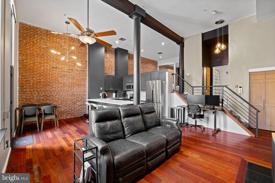 Welcome to 12 Letitia Street! A quiet block nestled into the heart of Philadelphia's Old City neighborhood. Unit 101 is a seamless blend of loft-style living, modern convenience, and historic character. Stepping inside, past the tiled foyer, you're met with 14' ceilings, original beams/columns, exposed brick, and hardwood flooring throughout. From the moment you walk in, it feels like home. Freshly painted, this unit is drenched with natural lighting, brought in through the oversized newer windows(with electric shades), overlooking the semi-private outdoor space. Shared with the neighboring unit, this outdoor space just past the dining area, is the perfect place to dine alfresco in the warmer months. The chef's kitchen leaves little to be desired, featuring stone countertops, stainless steel appliances, tiled backsplash, and freshly painted cabinetry. Ascending the stairs, you're met with designer tile that leads into the recently renovated bathroom. Opposite the double vanity, you'll find your in-unit washer and dryer, cleverly hidden in a closet. As you reach the top of the landing, you'll find the bedroom, where the unit's character continues. The exposed brick wall is large enough to accommodate a king-sized bed, alongside a wall full of closet space. Outside of the unit, your amenities continue throughout the building. Take the elevator up to the 6th floor, to enjoy a shared roof deck, offering 360-degree views of the city. In the building's basement, you'll find a dedicated storage space for unit 101. Even the graciously sized secured lobby exudes the same character and charm of the unit. City living at its finest, with a near-perfect walk score of 99, everything is right at your fingertips. Steps away from some of Philadelphia's best restaurants(including critically acclaimed Zahav), the EL, and the $ 2 billion Penn's Landing Park project, which is currently underway. A great opportunity to own a piece of Philadelphia's history!