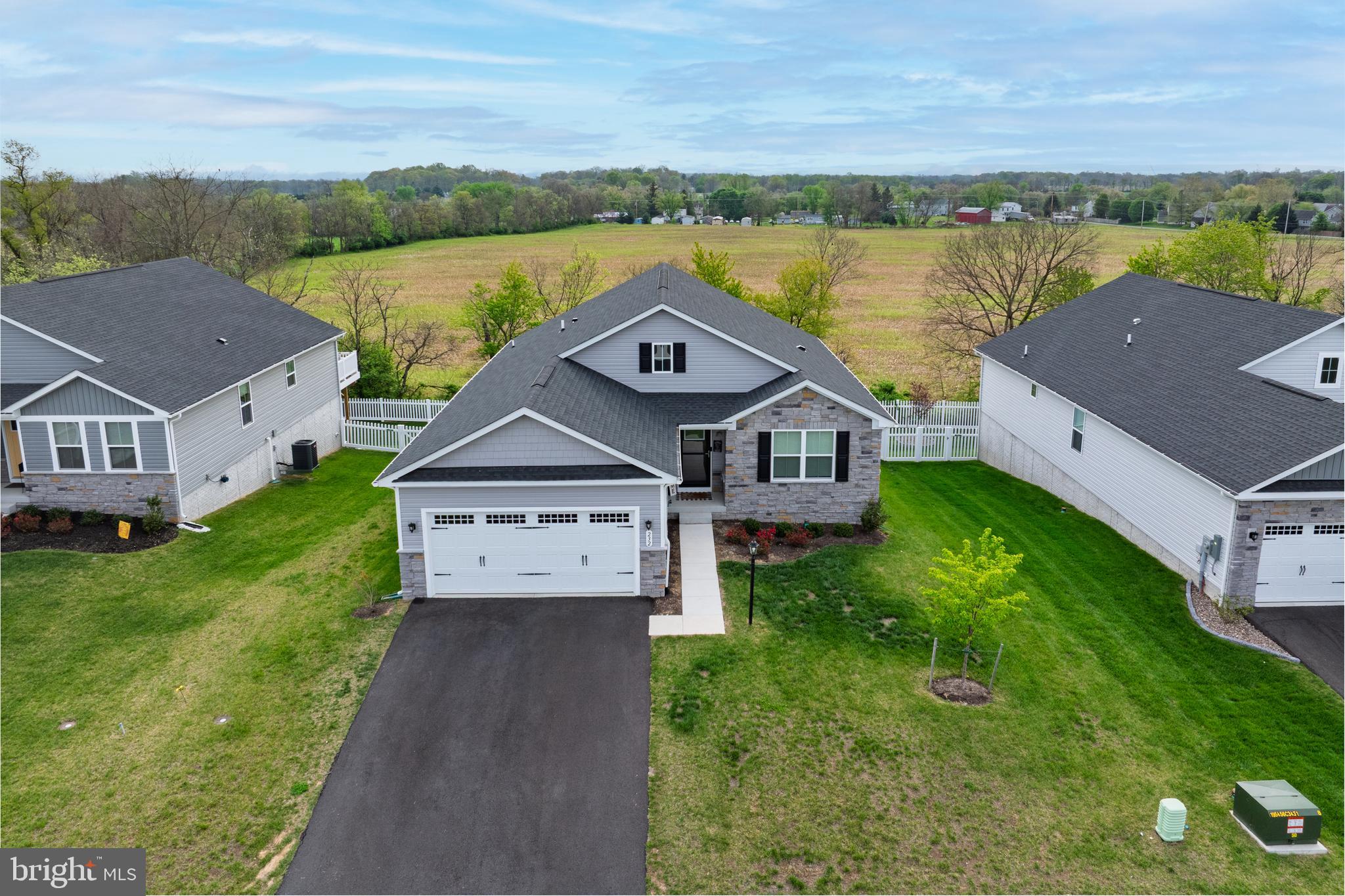 Welcome to this rare Dominica Spring floor plan home. Own this less than 2 years old, barely lived in home home without the wait!! Nestled in the prime location of Martinsburg, West Virginia, this stunning modern ranch-style open concept home offers the perfect blend of comfort, style, and potential. Boasting three spacious bedrooms and two full bathrooms with an additional flex space ideal for an office, formal dining room or additional sitting room. The main level also features LVP throughout the ENTIRE home, offering a sleek and modern feel. The kitchen offers a large island ideal for sitting, stainless steel appliances, farm house style stainless steel sink, large pantry, and dining area ideal for family get togethers and entertaining. Head downstairs to the huge walk-out basement, which backs to peaceful greenery, offering a serene view and added privacy. The expansive 1,700sf unfinished basement provides endless possibilities to make it your own, with rough-in plumbing already in place for a third bathroom—ideal for future expansion or creating a custom retreat. The two car garage is already equipped and ready to charge your electric vehicle. With its unbeatable location and abundant space inside and out making this home potentially over 3400sf. You wont want to miss the opportunity to own a newly constructed home without the wait of new construction.