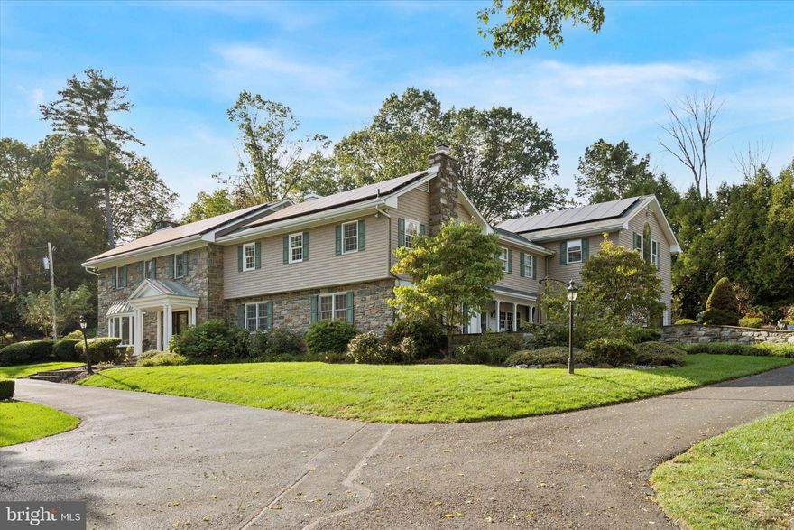 Set behind newly upgraded gates with an advanced security camera system, this exceptional estate offers a rare combination of privacy, sophistication, and modern convenience. Nestled on 3.56 meticulously manicured, park-like acres, the 6,010-square-foot custom residence seamlessly blends timeless European character with today’s most desirable upgrades.
A striking stone exterior introduces the level of craftsmanship found throughout, while a dramatic two-story foyer welcomes you into a home defined by scale, elegance, and warmth. Freshly painted interiors enhance the light-filled main living spaces, including a grand 17 x 30 formal living room and an impressive two-story great room featuring a built-in cherry wet bar, projector, and drop-down screen—perfect for entertaining on any scale. Rich hardwood floors, hand-crafted moldings, designer finishes, and four beautifully restored and serviced fireplaces add depth and refinement throughout. French doors lead to a stunning stone and slate courtyard, creating a seamless indoor-outdoor living experience.
The chef’s kitchen is designed to impress, anchored by a massive island with Shivakashi granite, Rutt custom cabinetry, and a full suite of top-tier appliances, including Gaggenau, Viking, Asko, and Sub-Zero. A formal dining room and an elegant library with custom-built cherry cabinetry complete the main level.
The private primary suite wing serves as a luxurious retreat, offering a spacious bedroom, a separate sitting room with its own deck overlooking the pool and grounds, a dressing room, and a spa-inspired bath with heated floors and an expansive double steam shower. A newly installed wood stove adds warmth and ambiance to the suite. Upstairs, three additional bedrooms and a full bath provide comfortable accommodations for family and guests.
Outdoors, the property continues to impress with a newly heated, custom-designed pool, enhanced by a new propane heater (2024), surrounded by mature landscaping, fountains, and multiple bluestone and slate patios—ideal for both relaxation and entertaining.
This home is equally distinguished by its extensive list of modern upgrades and efficiency features, including a high-performance solar energy system with 96 panels and two Tesla Powerwalls, offering energy storage and the ability to return power to the grid. A 400-amp electrical system with circuit breaker overload protection, four-zone heating and cooling, a new first-floor HVAC unit (2023), and five new Ecobee thermostats (2025) ensure optimal comfort and efficiency. Additional improvements include a new hot water heater (2022), new well tank (2023), whole-house filtration system (2025), and reverse osmosis system in the kitchen (2022).
Technology and security have been thoughtfully enhanced with a fully upgraded ADT system and whole-home wired ethernet servicing the office, great room, den, playroom, and eight wired wireless access points, including outdoor coverage extending to the pool area.
Additional recent updates include a new front gate with operator and control system, new roof over the kitchen (2025),  and upgraded RainBird irrigation controls (2023).
Completing the property is an attached two-car garage with electric vehicle charging stations and a separate carriage house featuring a three-bay garage and a finished, climate-controlled loft currently used as a private gym.
Impeccably maintained and truly turnkey, this extraordinary property offers the ultimate in privacy and luxury, all within close proximity to New Hope, with convenient access to Philadelphia, Princeton, and rail service to New York City.