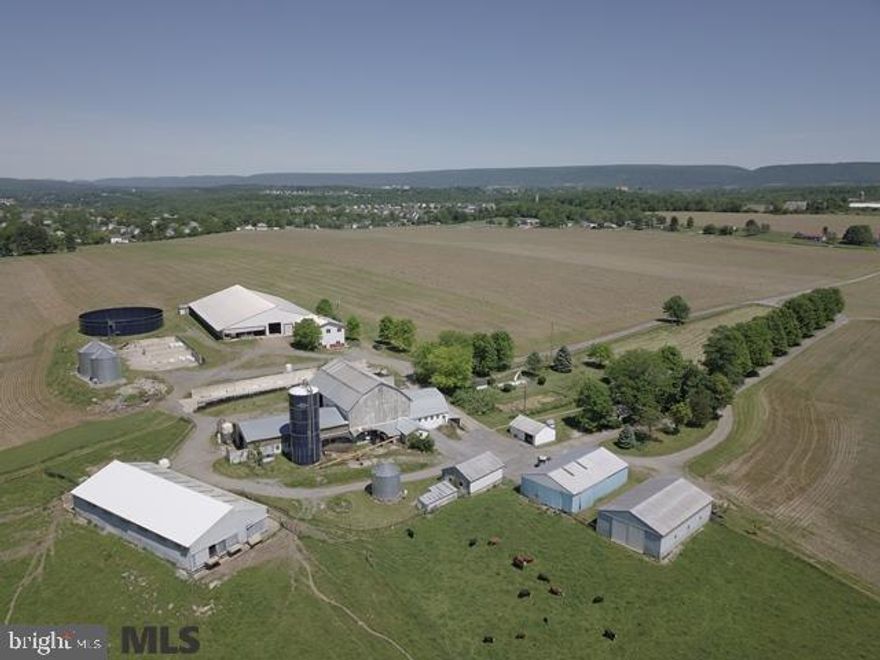 226.43 Acre Dairy farm located in Bellefonte, Centre County, PA. The tillable acres contain outstanding quality soils such as Hagerstown silt loam, Hagerstown silty clay loam, Hublersburg silt loam, Lindside, and Clarksburg silt loam. The ?state of the art? dairy facilities include a Double-8 Herringbone parlor. 2 bunker silos measure 27'x45' and 45'x210'. The free-stall barn measures 92'x112'. It originally had 180 free stalls. Approximately 100 free stalls were removed and the area converted to a bedded pack. There are additional dairy facilities & grain storage.  Main farm buildings are away from road traffic. There is a small amount of stream frontage in the back of the farm in the pasture area.  Original brick 2-story farmhouse with 4 bedrooms & 2 full baths.   Development rights not included.  Taxes will be reassessed due to the subdivision that is taking place.