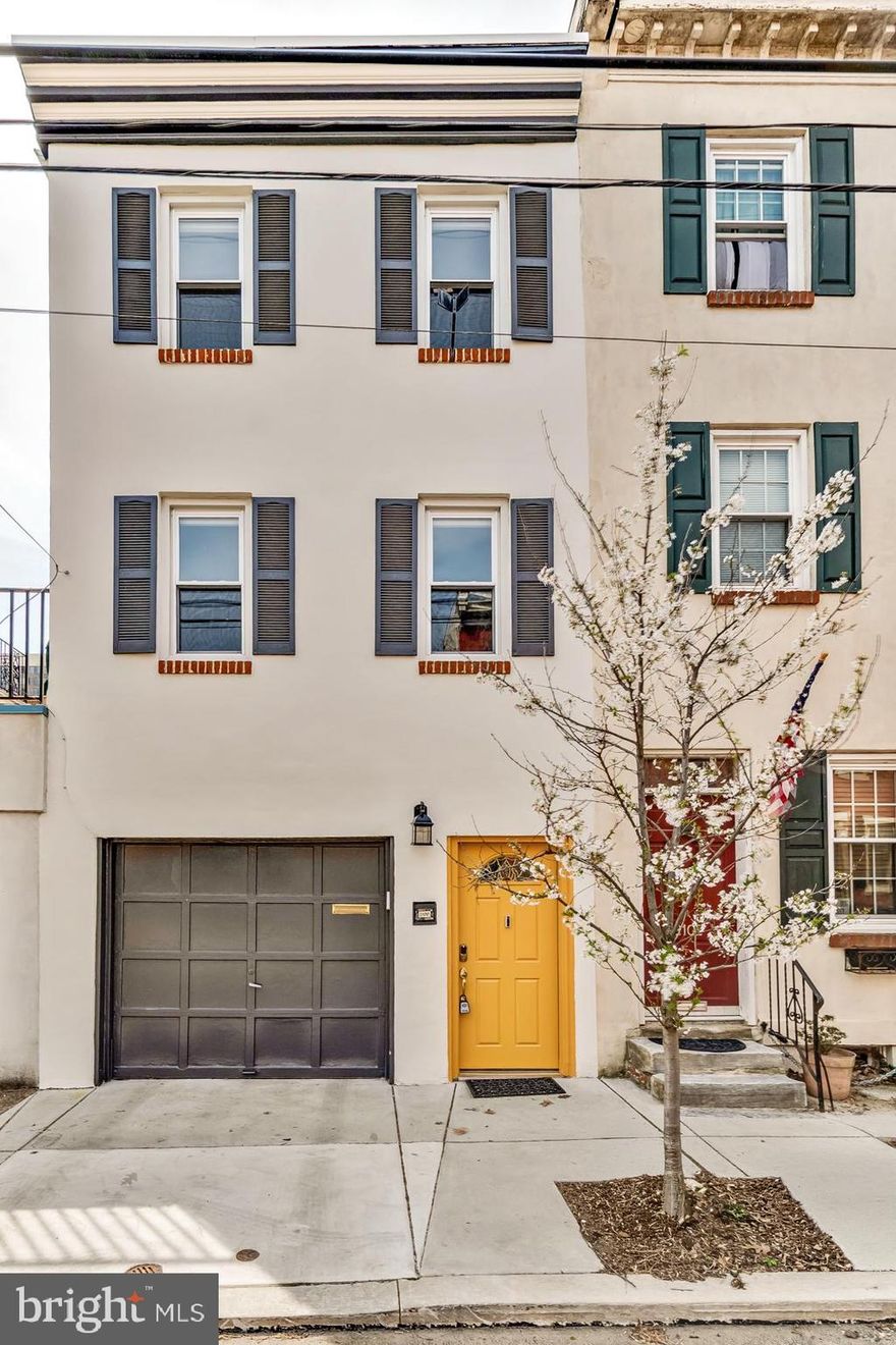 In a neighborhood defined by history, this residence stands as a modern marvel of convenience
and light. Located in the heart of the Spring Garden Historic District on a quiet tree lined block,
this home offers the one thing most city dwellers only dream of: a one car attached garage with
direct interior access.  On the lower level, a flexible, private suite with a full bathroom is perfect for multi generational  living,  a sophisticated guest wing,  a quiet home office or a fantastic family room.
Transition from the interior lower level to a large, tranquil patio. This private outdoor sanctuary is
perfect for fresco dining, container gardening or an evening of relaxation under the stars.
The second level features a sweeping open-concept floor plan designed for the modern lifestyle.
The gourmet kitchen is a focal point, anchored by stainless steel appliances, generous wood
cabinetry and an enormous walk in pantry that provides unparalleled storage. Whether you’re
hosting a formal dinner in a transitionless dining area or relaxing in the expansive living room,
the flow is effortless and inviting. Off of the dining room is an attractive deck with access to the
patio below.  As you move through the home, look up-a stunning skylight sits atop the staircase, flooding the
center of the home with natural light.  The upper level features two spacious bedrooms, a hallway bathroom, a dedicated laundry room positioned to make daily chores a breeze and the master bedroom and primary bathroom.  This home is conveniently located to public transportation, the Museum District, local shops and
restaurants, major highways, hospitals and universities.  Don’t miss this exceptional opportunity to live in one of the best neighborhoods in the city.