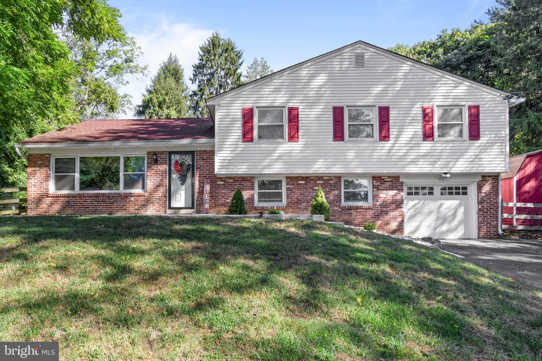 Welcome to 407 Leslie Lane in West Chester! Located in the heart of Westtown Township in the sought-after West Wynn development, this 4-bed, 2.5-bath split-level is situated on a near 1-acre lot in one of the most beautiful developments in all of Westtown.
First Floor:
Pull down this gorgeous street into the private driveway, walk up the sidewalk, and into the first floor. The first floor features a formal living room with hardwood flooring and neutral tones throughout. Walk from the living room into the formal dining room, which has fresh paint, recessed lighting, and custom wainscoting. The dining room connects to an eat-in kitchen featuring white cabinets, tile flooring, and a cozy eat-in area. The kitchen leads directly to the rear deck overlooking the yard.
Lower Level:
On the lower level, you'll find a family room area with a gorgeous black brick fireplace, perfect for entertaining. Off this room is a utility room with access to the attached garage, and the utility room also includes a powder room and laundry area.
Upper Level:
The upper floor offers four perfectly sized bedrooms, including a primary suite with a large closet, walk-in shower stall, and a private primary bath. The hall bathroom features an updated vanity, tile flooring, sliding glass bath doors, and a tile surround.
Exterior:
Step out of the eat-in kitchen onto a gorgeous deck overlooking the enormous, three-level yard with endless potential. It's an outdoor space ready to be customized to your needs. Take in your morning coffee as the deer walk through the back yard, stunning private views of nature in this secluded yet convenient location.
Additional Upgrades Include:
In 2023, the entire house was painted. In 2024, a new garage door was installed and the patio area was sealed. In 2025, a new AC condenser was added.
Local Vibes:
Just minutes from downtown West Chester Borough and close to local hotspots like Lo Piccolo Pizza. Enjoy easy access to Route 352, Route 3, and other major highways. The location truly has it all.