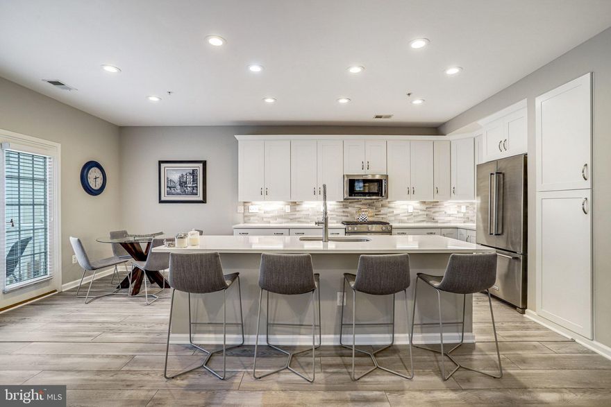 Featuring a sleek modern redesign combined with meticulous craftsmanship, 358 Urban Ave offers unparallelled value in an amenity-rich and ideally located community.  The sun-drenched south-west facing residence is awash in natural light from the large soundproof, energy-efficient windows offering sweeping views. A top-level duplex, this unit offers nearly 3000 square feet of recently renovated elegant finishes and open-concept living.  

Luxury plank flooring provides a stunning backdrop to the expansive main living area offering a peaceful and composed feel.  The gorgeous, recently redesigned chef’s kitchen features quartz countertops, a professional grade appliance suite, an oversized island, a sunny breakfast area, and access to the private balcony. Easily flowing into the family room featuring a captivating stone-surround gas fireplace, built-in sound system, and recessed lighting, this sophisticated space anchors the home. The large separate dining area effortlessly accommodates seating for eight and flows gracefully into the spacious living room offering bright windows with lovely views.

The upper level is crowned by a large primary suite offering two large walk-in closets, a tray ceiling, and a spacious spa-inspired en-suite bathroom with dual vanities and an oversized walk-in shower featuring twin shower heads. Two additional bedrooms, a hall bath with double sinks, and a separate laundry room complete this level. There is access to the attached Garage from the Entry Level Foyer.

Located in the City of Gaithersburg, The Parklands is a pedestrian-friendly community with wide, tree lined streets and sidewalks. The resort-like amenities include a pool, tot lots, tennis court, club house, fitness center and meeting room.  This location is a commuter’s dream! It’s a short, 5-minute walk to the Metropolitan Grove MARC Train station, minutes to Downtown Crown and Kentlands, close to major commuter routes, and minutes to NIST, Adventist Healthcare, AstraZeneca, Novavax, and Lockheed Martin.  The interchange at exit 12, Watkins Mill Road, provides convenient access to I-270 and the ICC (I-370). The Shops at Spectrum Center are just a short walk away. The drive time to the Shady Grove Metro is about 10 minutes! A peaceful haven tucked away for privacy but still conveniently located near it all, living in the Parklands gives you the best of everything!