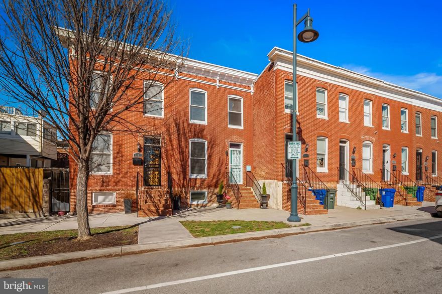 TAXES LESS THAN $500/year for approximately the next 3 years! Beautiful 2017 CHAP renovation just steps from Johns Hopkins! Meticulously maintained with fun and tasteful updates throughout, this home is just like new! The main level greets you with a wide open floor plan, spacious living room, exposed brick, and fantastic natural light. Timeless kitchen with light granite counter tops, white cabinets, subway tile backsplash, Grohe cast iron sink, Blanco kitchen faucet and high end SS appliances. Trendy powder room in the rear of the home. 2 spacious bedrooms and bathrooms upstairs. Primary suite in the front of the home with fantastic natural light, ample closet space, and ensuite bathroom with an upgraded double-vanity. Access to your two-level ROOFTOP DECK off of the second bedroom with fantastic city/skyline views. (Roof deck stained recently and roof silicone coat applied in 2021.) Finished basement (can be used as a 3rd bedroom) with thoughtfully built-in storage shelving and side-by-side laundry. Large fenced in rear patio with pavers, a wonderful oasis or for entertaining or your gardening dreams! Fantastic Live Near Your Work (LNYW) incentive available and don't forget about the CHAP Tax Credit, making your taxes less than $500 a YEAR for approximately the next 3 years. (Buyer to verify.)