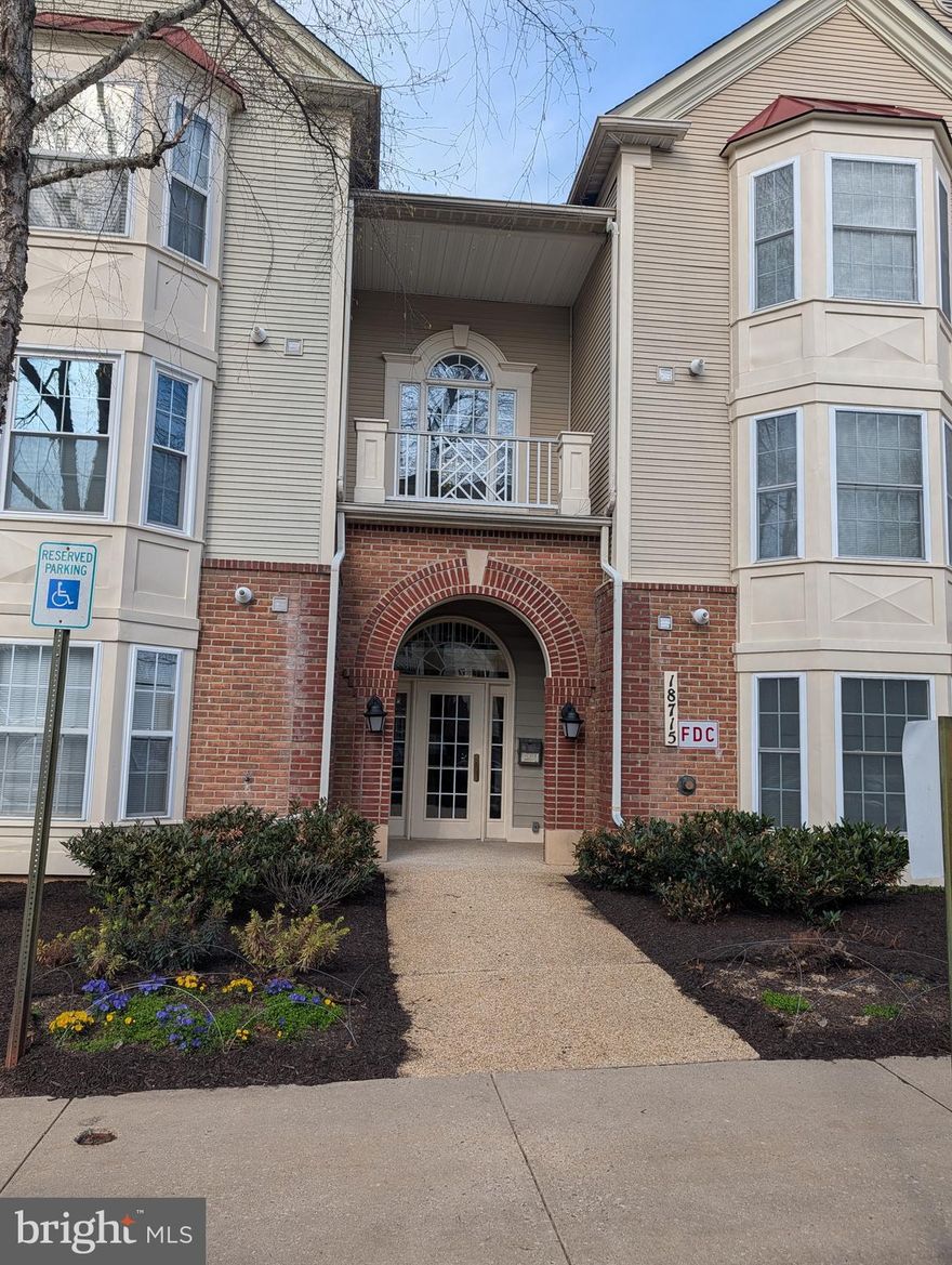 This mid-level condo overlooks wooded open space facing the rear of the building while enjoying a designated parking space in front.  Across the street is a beautiful park with a fountain reminiscent of the name of this delightful community. it will soon have fresh paint and new flooring. As the weather warms, crews are out mulching and planting beds throughout the community and more crews have been seen preparing the pool for residents to enjoy this summer.  There are ball fields and play areas for children of all ages within this community as well.  This condo has two en suite  bedrooms each with a full bathroom and a walk-in closet.  The bedroom suites are on opposite sides of the living space in the middle of the condo. The living room in the center of the condo opens to a balcony overlooking the woods and the living room has a fire place.  There is plenty of room for stools at the kitchen counter which overlooks the living and dining spaces. Both bedrooms and the living room overlook the wooded area out back. Washer and dryer are just inside the condo off the foyer.  Shopping and restaurants are nearby in a shopping center across from one of the entrances to the community.  Not far from the community college either.