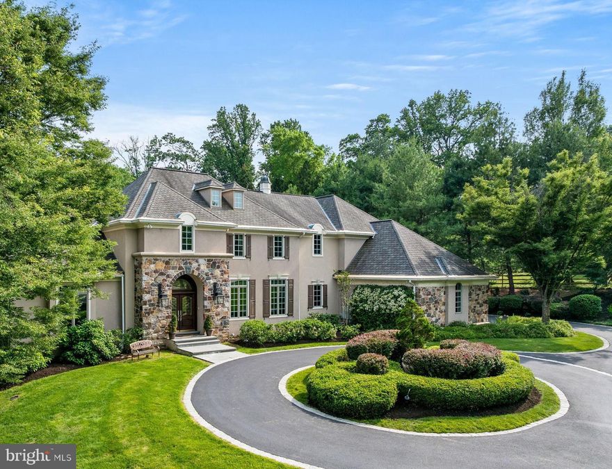 Welcome to an exquisite estate that seamlessly blends luxury, comfort, and privacy. Nestled on a picturesque 3.25-acre lot, this extraordinary 5-bedroom, 4.3 bath home offers over 6,900 square feet of elegantly designed living space—an entertainer’s dream and a true retreat from the everyday. Uniquely distinguished with its striking stone & stucco exterior, stunning lush grounds, circular Belgian block-lined drive & 3-car built-in garage, and situated on a prime cul-de-sac setting.  

The grand entrance will not disappoint with stunning two-story foyer, soaring ceilings, marble flooring, an upper balcony, a staircase with custom Italian stair pewter & brass rail & gracious open archways to main rooms. A rear window wall showcases scenic property views.  At left is a rich cherry-paneled library with coffered ceiling, bookcase wall, charming window seat and fireplace.  Directly across the library, you will find an  elegant, formal wainscoted dining room.   French Provincial interior elements and architectural features adorn the interior, brimming with quality craftsmanship & attention to detail. Beautiful trim & woodwork, custom stained glass windows, extensive built-ins, Brazilian cherry hardwoods, an antique fireplace mantle from Vermont, upscale modern finishes & a beautiful wall to wall wooded private elevator that services the basement, first floor and 2nd floor, all accentuate this magnificent home.  The gourmet eat-in kitchen with custom wood cabinetry, an expansive granite island & counters, wood-beamed ceilings & top-of-the-line Thermador/Sub-Zero appliances is a chef s dream. The open breakfast room receives brilliant sunlight, with glass doors to the rear patio retreat. Huge arched floor-to-ceiling windows overlook gorgeous greenery in the magnificent family room, highlighted by a vaulted ceiling with arched trusses, custom gas fireplace & built-in entertainment center.  Additionally, you will find a divine 1st floor primary owner's suite with  handsome  custom-fitted walk-in closet & generous en-suite bath.  Completing the first floor are 2 powder rooms (one with a hand-painted Sherle Wagner sink) and an expansive laundry room.

 The 2nd story presents 4 sizable bedrooms (2 en-suite) with lots of light & closet space, and 3 finely-appointed full baths. A child s whimsical wonderland with magical wall montages and a stationary carousel on the 3rd floor is an absolute showstopper. The finished walk-out lower level extends living/entertaining space with a family room, cherry-paneled wet bar/kitchen area, state-of-the-art home theater that seats 9, an office, home gym, and doors to a patio with pergola. Enjoy life in the quiet countryside, in a prestigious neighborhood convenient to great shopping, schools, Wegmans, Whole Foods, King of Prussia & major roadways!

Outside, the expansive 3.25-acre grounds provide privacy and serenity, with plenty of space for outdoor enjoyment and future enhancements. The private, spacious terraced backyard oasis includes a wooded sanctuary complete with winding stone walkways.