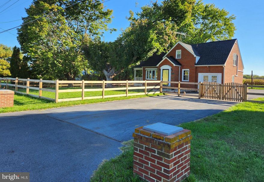 What a Charmer!  Brick Cape Cod so convenient to amenities, yet feels like being out in the country.  Gorgeous new wood & wire fence surrounds this comfortable home with tons of character.  Hardwood floors, tile in kitchen and bath, wide baseboards, crown molding, wood French doors with glass panes, bow window in living room and a brick fireplace - and the cutest covered side porch.  Also on the main level is a “side room” bonus room with separate entrance, could be used as an office, den or additional bedroom.  Has entry through the back with a mud room area.  The front entry also has storage foyer for boots and shoes, jackets and accessories.  Kitchen is very spacious with lots of counter space.  Dining room fits a large table with area adjoining the kitchen counter for extra seating on stools.  Raised concrete porch/patio off the kitchen for entertaining.  Finished with electric and heat, the detached 2-car garage has additional separate room for storage, workshop, hobby room.  Two separate access point full doors besides windows and the double garage door with opener.  Two of the bedrooms upstairs have wood coffered ceilings with fans.  Closets are spacious, Bathroom has tub with tile surround and a window for natural light to brighten the space.  Dry basement with concrete floors, lots of storage and laundry area with utility sink, washer and dryer stay!  Newer windows, 4 mini splits for cooling, kitchen built-ins, hall closets, Lots of space for parking for large gatherings.  Back yard is enormous and has a view of corn fields that adds to the privacy along the no-thru street.