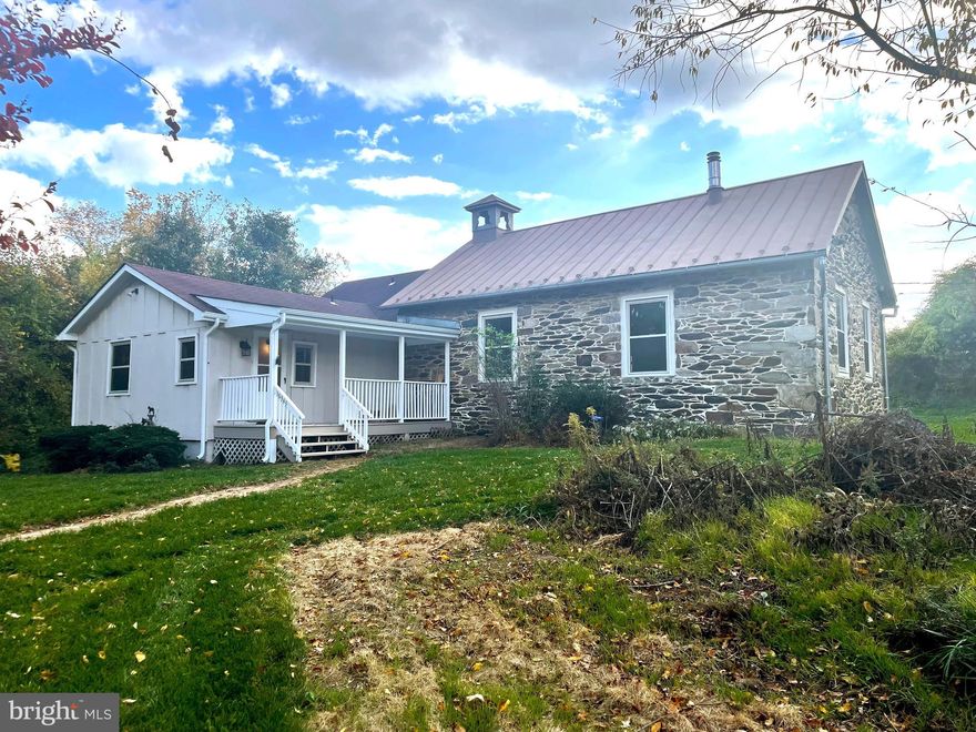 Nestled along the rolling hills of a picturesque 7 acre farm in the foothills of the Blue Ridge, this charming cottage is complimented with nearby horse and cattle pastures lining scenic country roads.  The mid-19th century stone schoolhouse was added to in the 1980s to include 3 bedrooms, two full baths and a loft area for play, study or work. A recent and full professional renovation (including all new appliances, HVAC, paint, flooring and plumbing) gives you a balance of modern comforts and rustic charm with open space for the living room, dining room and fully appointed kitchen. An iron wood stove is the focal point of this space, creating a warm and comfortable ambiance.  The cottage’s charm extends outdoors with a front porch that is a welcoming part of the home, providing a serene vantage to immerse oneself in the surrounding pastoral beauty.  This unique home, while sharing the landlord’s property, stands at a distance as a secluded separate entity from the main house.  It is your haven of comfort and serenity—a distinctive retreat that is a blend of history, charm and modern living.  Welcome home to the comfort and serenity of a peaceful community only minutes away on a well maintained road to schools, shopping and services.