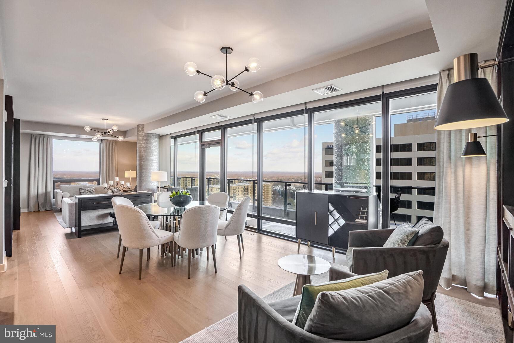 Priced to Sell!! Leasing permit that conveys valid through September 20th. Experience Unparalleled Luxury at The Verse, Unit 1307. Welcome to a masterfully designed corner residence that epitomizes modern elegance and sophisticated living in Tysons’ vibrant Boro neighborhood. This 2-bedroom, 2.5-bath residence spans 1,689 square feet and features over $110,000 in premium upgrades and custom finishes including $100,000 in high-end enhancements and an additional $10,000 in bespoke closet systems. Originally crafted as the builder’s model home, this residence delivers a seamless blend of comfort, style, and functionality, with breathtaking views of the mountains and skyline. | A Sophisticated Sanctuary: The moment you step into Unit 1307, you’re welcomed into an open-concept layout framed by wide-plank wood floors and floor-to-ceiling windows that flood the space with natural light. The expansive private balcony invites you to relax or entertain with stunning panoramic views, while the chef-caliber kitchen sets the stage for culinary artistry. The kitchen, custom-designed by Cecconi Simone, boasts: Full-height Italian cabinetry with integrated storage; Composite stone countertops with a dramatic waterfall edge; Bosch appliances, including a concealed refrigerator, dishwasher, and microwave; A wine fridge, five-burner gas cooktop, and wall-mounted oven; and Oversized Island with seating, storage, and USB ports. The primary suite is a private retreat, offering custom-built dual walk-in closets with mirrored doors and a spa-inspired bath featuring porcelain Calacatta marbleized tile, a frameless glass shower with an integrated bench, and a custom Italian vanity with built-in linen cabinetry and warm LED edge lighting designed for makeup application and nighttime comfort. The secondary bedroom is equally luxurious, with an ensuite bath, custom closets, and abundant natural light. Additional conveniences include a stylish powder room, a dedicated laundry room with a stacked washer and dryer, two private garage parking spaces, and a premium storage locker, #30, on the third floor. | Luxe Amenities That Elevate Everyday Living: The Verse offers an array of resort-style amenities designed to complement your lifestyle, whether you’re seeking tranquility or vibrant social spaces. Key amenities include: Stunning Lobby providing an inviting oasis with warm wood and stone finishes, plush fireside seating, and a 24/7 concierge team ready to serve you; Grand Entertainment Lounge with soaring windows, flexible spaces for private events, a 14-foot glass-top island, and an outdoor kitchen featuring Wolf gas grills; One-Acre Skypark offering a lush outdoor retreat with communal dining areas, fire pits, a badminton lawn, and a covered kitchen with bar seating; High-Performance Fitness Studio fully equipped with cardio and weightlifting machines, a yoga studio with programmed workouts, and an outdoor Zen terrace; and an Outdoor Pool for relaxing poolside with chaise lounges and panoramic views. Additional features include a pet spa, a guest suite with hotel-like amenities, secure bike storage with a repair station, and private resident storage units. The secure resident-only garage offers EV charging stations and preferred parking for fuel-efficient vehicles. | A Curated Lifestyle at The Boro: The Verse is located in the heart of The Boro, Tysons’ premier mixed-use neighborhood. Steps away, you’ll find upscale dining options, including North Italia, Circa, and Flower Child, the flagship Whole Foods Market and ShowPlace Icon Theatre, and pedestrian-friendly streetscapes. With easy access to the Silver Line Metro via Greensboro Station and major roadways, The Verse provides unmatched connectivity while offering a serene refuge from the hustle and bustle. | Your Luxury Living Awaits: Enjoy this rare opportunity to own a meticulously curated residence where the only thing missing is you.