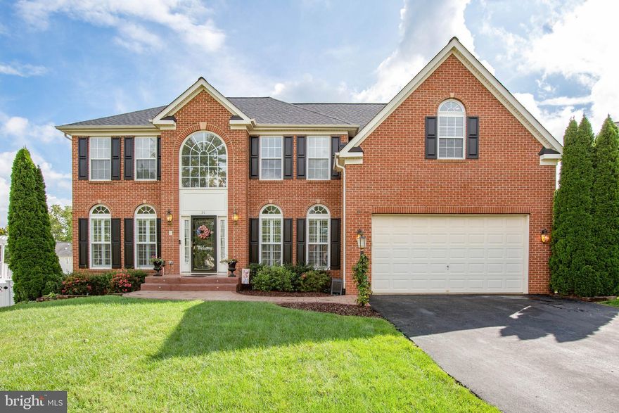 CURB APPEAL & PRIDE OF OWNERSHIP are immediately evident in this SPACIOUS,  BRICK FRONT colonial located on a CUL DE SAC in sought-after STOWE of AMYCLAE.  As you enter, a 2-STORY FOYER & well-appointed LIVING ROOM & DINING ROOM greet you.  Both rooms feature gorgeous PLANTATION SHUTTERS & CROWN MOLDING.   Notice the DECORATIVE LIGHTED WALL INSERT showcased in the hallway as you enter the home.  Perfect appointments to the spacious FAMILY ROOM include a SOARING CEILING &  STACKED STONE GAS FIREPLACE complete with MANTEL & HEARTH! The  GOURMET KITCHEN with DOUBLE WALL OVENS (one convection), GAS COOK TOP,  NEW REFRIGERATOR, DISHWASHER, BUILT-IN MICROWAVE,  WALK-IN PANTRY & impressive ISLAND will be a delight for meal preparation!  Opening from the Kitchen is  a bright & airy SUN ROOM with a VAULTED CEILING and EXIT onto a generous COMPOSITE DECK offering STAIRS to the rear yard &  UNDER-DECKING for a rain-proof space beneath.  The open configuration of the family room, kitchen & sun room create a PERFECT ENTERTAINMENT SPACE!  The MAIN LEVEL is complete with an OFFICE that features BUILT-INS & a beautiful FRENCH DOOR entry,  a separate LAUNDRY ROOM with a utility sink &  a HALF BATH.  Gorgeous WOOD FLOORING is highlighted in the entry, dining room, kitchen, sun room, office & half bath.  Dual wooden staircases offer access to the upper level from the main entry and kitchen area.   The home's UPPER LEVEL offers a SPACIOUS OWNER'S SUITE appointed with 2 WALK-IN CLOSETS, TRAY CEILING & CEILING FAN/LIGHT.   Step-down INTO a LUXURIOUS SPA BATH complete with JACUZZI TUB, SEPARATE SHOWER & SEPARATE SINKS with upgraded CABINETRY.  Completing the UPPER LEVEL are 3 ADDITIONAL BEDROOMS, one with a WALK-IN CLOSET,  plus a FULL BATHROOM featuring DUAL SINKS with CABINETRY & a TUB/SHOWER combination.  The FINISHED LOWER LEVEL  features an ENORMOUS RECREATION  ROOM that can be set up with separate spaces to enjoy to include an EXERCISE AREA,  TV/MOVIE AREA & GAME ROOM.  A BONUS ROOM can serve as a 5th (not to code) BEDROOM  & attaches to a FULL BATHROOM appointed with vinyl tile flooring & tiled shower.  From the lower level WALK-OUT exit,  enjoy the FULLY FENCED REAR YARD from a SPACIOUS STAMPED CONCRETE PATIO complete with BUILT-IN FIRE PIT and LED LIGHTING.  Finishing off the outdoor space is a STORAGE SHED for all your garden & lawn needs.  This amazing home boasts over 5,000 FINISHED SQUARE FEET and provides all the added EXTRAS in a location with AWARD WINNING SCHOOLS & easy access to Quantico & I-95.