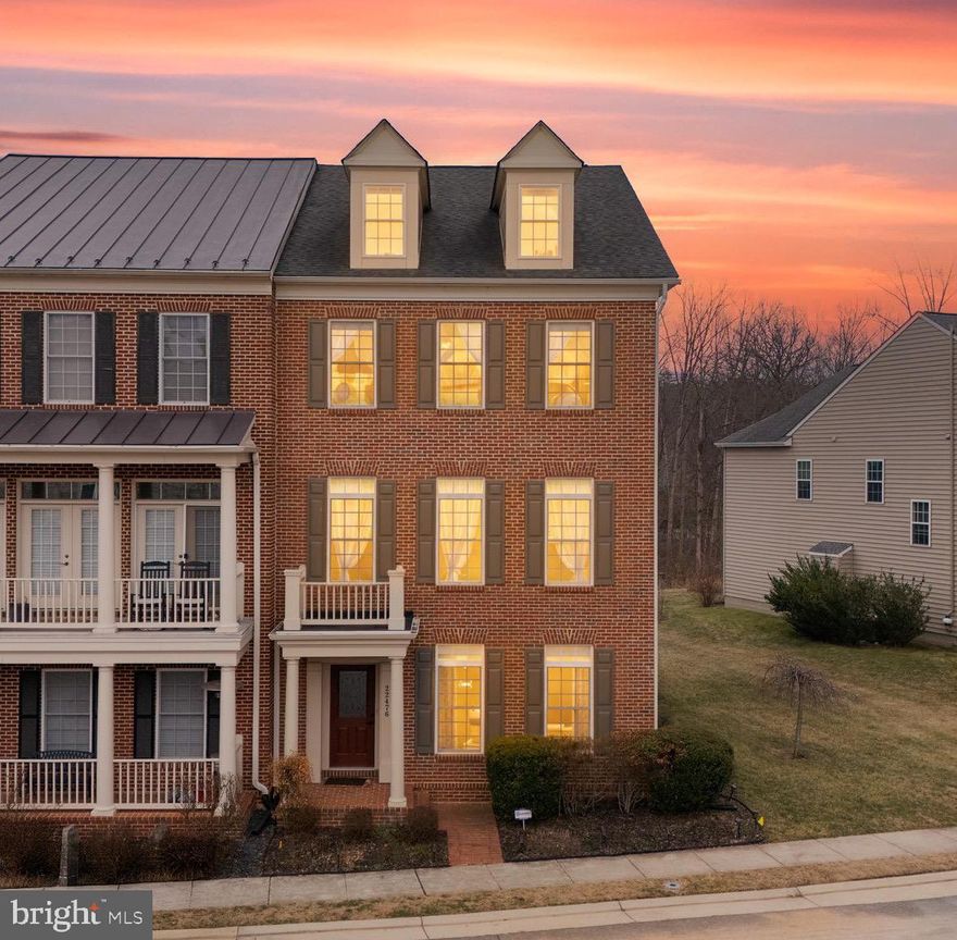 Welcome to this stately all-brick end-unit townhome with over 3,000 square feet in the highly sought-after Greene Mill Preserve 5 minutes from Brambleton! Featuring a rear-load two-car garage and exceptional privacy, this light-filled home backs to mature trees and tranquil pond views. The HVAC system was replaced in 2024, offering added value and peace of mind. The open and bright floor plan showcases gleaming hardwood floors, a formal living and dining room, and a spacious family room with fireplace and walkout to a private deck overlooking lush open space. The gourmet kitchen is beautifully appointed with a center island, granite countertops, stainless steel appliances, and neutral backsplash, perfect for entertaining. The entry level offers a private en suite bedroom and media room, ideal for guests or multi-generational living. Upstairs, retreat to the luxurious primary suite with vaulted ceilings, cozy fireplace, sitting area, two large walk-in closets, and an elegant spa-like bath. Residents of Greene Mill Preserve enjoy resort-style amenities including scenic walking trails, a village green, community pool, playgrounds, butterfly garden, tranquil pond, and expansive preserved green space all just minutes from Brambleton, major commuter routes, and top-rated schools. A rare end-unit offering combining space, privacy, and upscale finishes, this is one you do not want to miss!