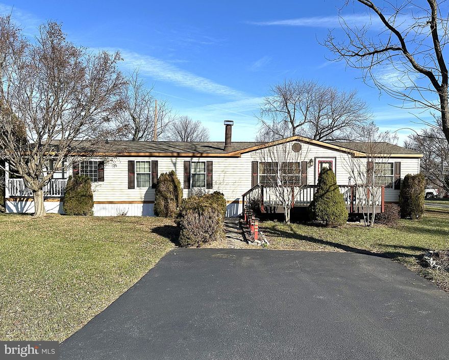 Very Well-Maintained Double Wide in Sought After Pheasant Ridge Mobile Home Community! This Beautiful Home sits on a Big Corner Lot at the end of Ridge Drive. Inside Features a Large Living Room with a Wood Burning Fireplace, a Big Kitchen with Lots of Cabinets, Counter Space and an Island, Just of the Kitchen is a Bonus Room that can be used as a Breakfast Nook or an Office. There is a Big Primary Bedroom with a Private Bath, Soaking Tub, Double Vanity Sinks, Double Shower and a Walk-in Closet. Recent Updates Include Roof, HVAC and Beautiful Laminate Flooring in Living and Dining Rooms, and Carpet in the Bedrooms. Outside you have a Nicely Landscaped Lot with a Custom Front Sundeck, a Big Covered Porch and a Two Car Driveway. Close to Schools, Parks, Shopping and Restaurants. Minutes to Rt 70. Don't Delay, be sure to contact me soon for a Private Viewing!