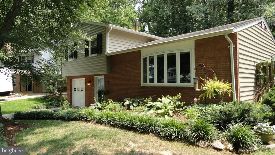 Gorgeous Fully Renovated, Custom Gourmet Kitchen, Huge sink in Island with granite countertop,  gleaming wood floors, new Ceramic Tile, new windows, custom 3 tiered deck, wonderful landscaping, new windows and skylights in sunroom Remodeled baths, upgraded electrical, new furnace, and water heater, Stainless appliances, Wonderful custom designed built in Book case. Please Remove shoes.