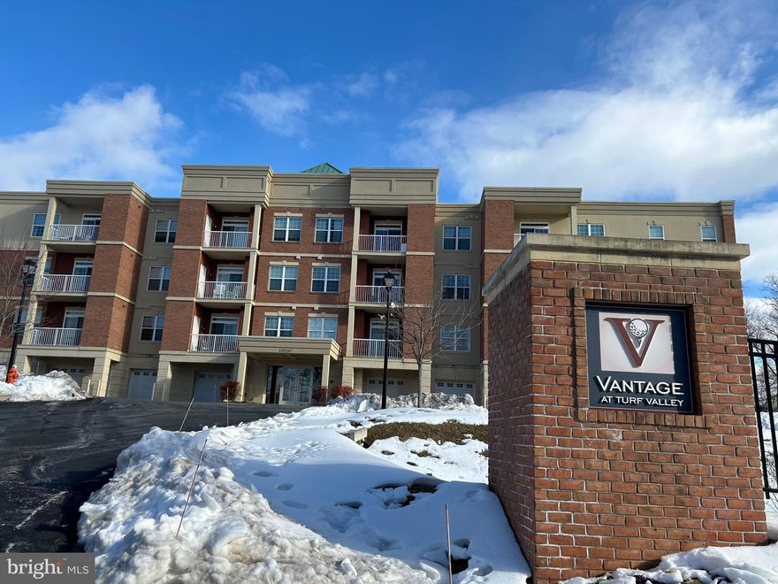 Discover a charming residence nestled in the desirable Turf Valley community, where modern comfort meets timeless elegance. This beautifully designed unit, part of the Vantage at Turf Valley, offers a perfect blend of style and functionality, making it an ideal choice for those seeking a serene living environment. Step inside to find an inviting open floor plan that seamlessly connects the living, dining, and kitchen areas, creating a warm atmosphere perfect for both relaxation and entertaining. The gourmet kitchen is a chef's dream, featuring upgraded countertops, an island for additional prep space, and ample room for a cozy table. With high-quality appliances and in-unit washer and dryer, every convenience is at your fingertips. The interior boasts plush carpeting and elegant wood floors, complemented by ceiling fans that enhance the airy feel of the space. The primary suite is a true retreat, complete with a spacious walk-in closet and a luxurious primary bath, ensuring comfort and privacy. Thoughtful details like an intercom system add to the modern conveniences of this home. Outside, enjoy the tranquility of your own balcony, perfect for sipping morning coffee or unwinding after a long day. The community features well-maintained common grounds and sidewalks, inviting you to take leisurely strolls in a picturesque setting. With an attached garage providing inside access and additional parking options available, convenience is paramount. Located in a vibrant area, this residence is close to various amenities, ensuring that shopping, dining, and recreational activities are just moments away. This property is in excellent condition and ready for you to call it home. Experience the perfect blend of comfort, style, and convenience in this delightful Turf Valley residence. Don't miss the opportunity to make this inviting space your own!