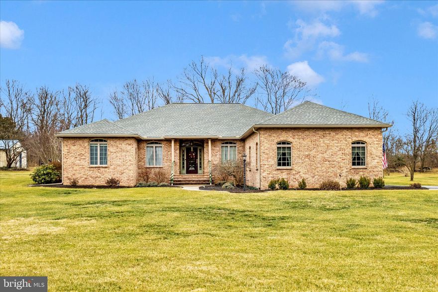 Upscale, custom-built Cushwa solid brick rancher set on 1.86 beautifully maintained acres.  This exceptional home offers a thoughtfully designed layout with split bedrooms, 9-foot ceilings, and heated ceramic tile flooring and upgraded carpet throughout the main living areas --combining comfort, quality, and timeless design.
The heart of the home is the gourmet kitchen, updated in 2015, featuring quartz countertops, a stone and glass backsplash, and premium stainless steel appliances--ideal for both everyday living and entertaining.  The living spaces flow effortlessly outdoors to a spacious covered patio overlooking a meticulously manicured, tree-lined lawn.  The patio is wired for a hot tub, creating the perfect extension of the home for relaxing or hosting guests. 
The primary suite is a true retreat, complete with a tray ceiling, new carpet, dual closets, and a luxurious en-suite bath with a walk-in shower, jetted soaking tub, and dual vanities.  Private access from the primary suite to the covered patio adds to the sense of comfort and retreat.  An additional bedroom or home office and a full hall bath--with convenient exterior access from the patio for guests--are located on this wing of the home.   Two additional bedrooms and a full bath are situated on the opposite side, offering privacy and flexibility.
Anderson double-pane windows and sliding doors are found throughout the home.  A two-car garage and a 24x24 outbuilding with stone flooring provide ample space for storage, hobbies, or workshop use.
In addition to its exceptional design and condition, the home has been meticulously maintained with all major systems already completed for peace of mind.  Recent updates include a new roof, gutters and downspouts, regularly resealed driveway, regularly updated landscaping and lawn care, new water heater, new propane boiler, with 1,000-gallon underground tank, new outdoor A/C unit, new air handler, new ductwork, new water softener system, and new UV bulb.  *See attached list of full upgrades and improvements*
This is a rare opportunity to own a beautifully crafted, move-in ready home where quality construction, thoughtful updates, and pride of ownership are evident throughout.