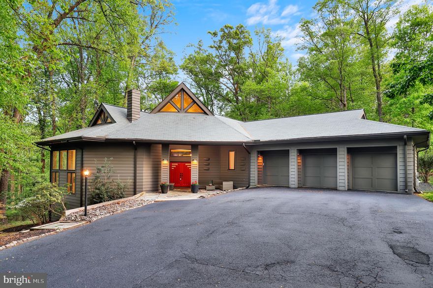 Welcome to this extraordinary custom contemporary home nestled on 1.65 peaceful acres at the end of a quiet cul-de-sac in sought-after Ellicott City. Offering nearly 5,000 square feet of luxurious living space, this meticulously maintained residence combines privacy, modern comfort, and exceptional craftsmanship. From its stunning architecture to its tranquil wooded views, this home is designed to impress.

As you step into the home, you’re immediately greeted by a bright and airy open floor plan, accentuated by soaring ceilings, oversized windows, and pristine hardwood floors throughout the main level. The gourmet kitchen features high-end appliances, granite countertops, and a large central island, perfect for both everyday meals and entertaining guests.

The expansive master suite provides a peaceful retreat, offering a sitting area, a large walk-in closet, and a spa-like en-suite bathroom with dual vanities, a soaking tub, and a separate glass-enclosed shower.

On the lower level, the fully finished walkout basement boasts a high-end in-law suite that is a completely self-contained unit, offering ample living space, a full kitchen, a luxurious bathroom, and a wood-burning stove for added comfort. This suite is perfect for multi-generational living, guests, or even as an income-generating rental unit. The suite also features its own 2-level deck, providing a private outdoor space for relaxation or entertainment.

The grand living room on the main level is the heart of the home, showcasing a stunning pellet stove that adds warmth and ambiance, perfect for cozy gatherings during cooler months.

Outside, enjoy a large deck and patio area that overlooks the lush, private yard—perfect for relaxing or hosting gatherings. The expansive lot allows room for a garden or future expansions, offering plenty of space for all your outdoor dreams. Surrounded by mature trees and nature, the property offers a peaceful retreat from the hustle and bustle of everyday life. Enjoy tranquility and privacy, with easy access to major roads, schools, parks, and shopping.

The home also includes a spacious 3-car attached garage, additional storage space, and a loft area that could be used as an office or den, perfect for working from home. With move-in readiness, this home is ready to accommodate your lifestyle. Conveniently located close to commuter routes, restaurants, shops, and parks, it offers the perfect balance of seclusion and accessibility.

Whether you’re seeking a peaceful retreat, a spacious home for entertaining, or a place to enjoy nature, this stunning property offers it all. Don’t miss your chance to make this home yours! Schedule your private tour today and experience firsthand all that this unique property has to offer.