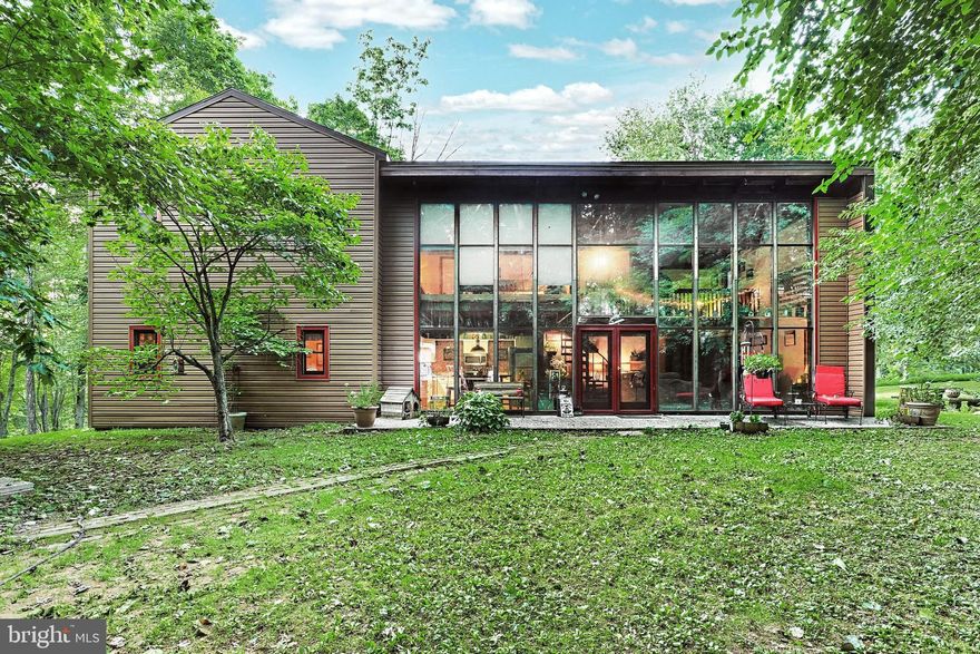 Seclusion at its finest! This custom home brings nature right to your door step and still delivers a convenient location. The rustic charm of the home greets you as you enter the home! Vaulted beamed ceilings, classic wood charm and character at every glance! The oversized 2.5 car garage has addltlional loft and office! Located just a few mins off I83 in Dtown Schools yet tucked perfectly in the woods! A home you will love to call yours!