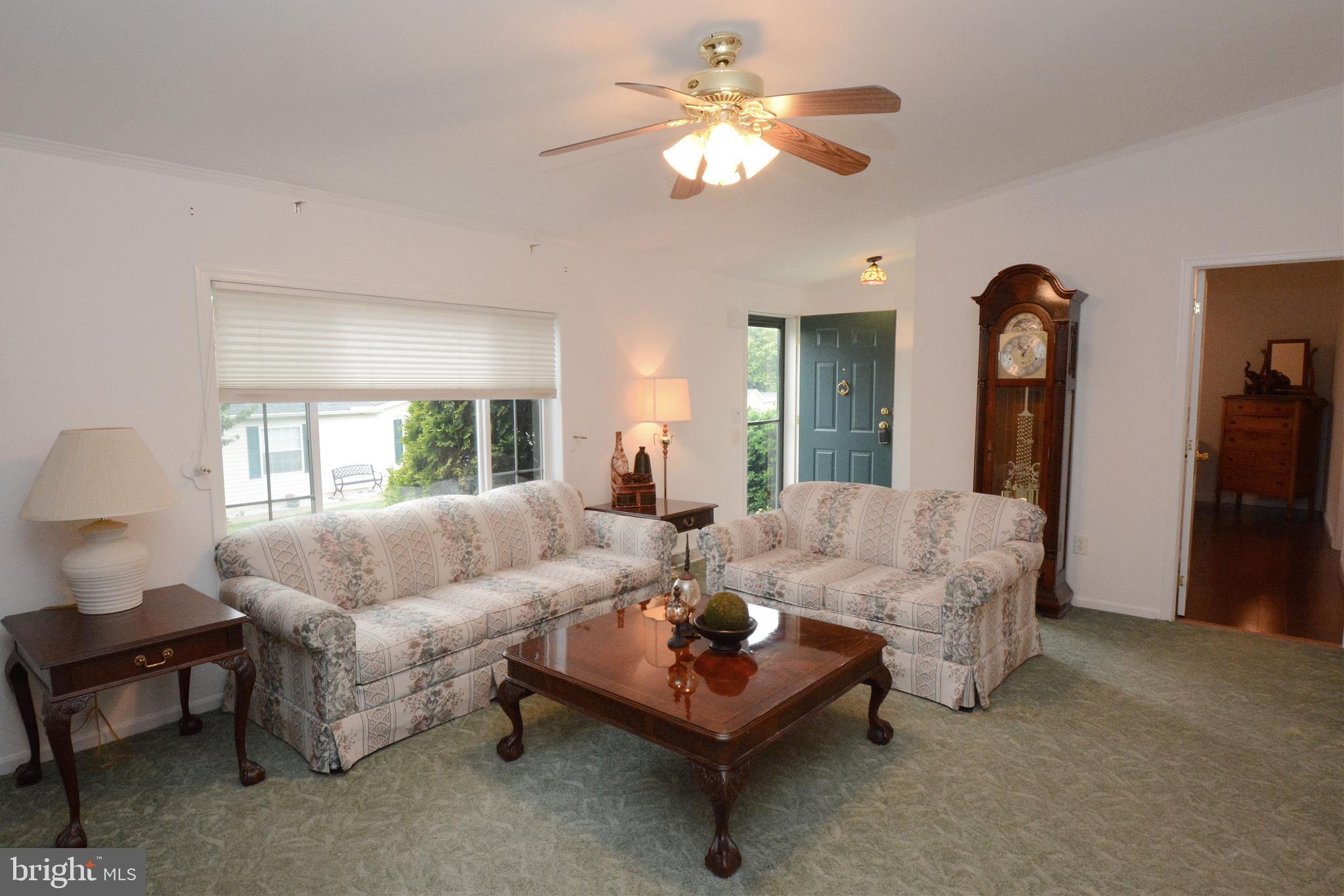 Welcome to this freshly painted (top to bottom) residence in the desirable Quiet Acres 55+ Community!
Step inside the front entrance to a spacious living room that opens into the dining area and kitchen. Plenty of counter space, a large island AND a walk-in pantry are some of the features that make this kitchen stand out. Off of the kitchen, you'll find a laundry room with interior access to the 1-car garage.
The primary suite is privately located on one end of the home and features a large bedroom, full bath with dual sinks, and a generous walk-in closet and freshly installed Luxury Vinyl Plank Flooring. On the other side of the residence, you'll find a full hall bath and a second bedroom with hardwood floors. Pass through this room to gain access to a third bedroom currently used as a home office—which also offers private access from the covered porch via sliding glass doors.
Enjoy peaceful mornings and evening breezes on the covered porch, a perfect spot for relaxing with a book or greeting friendly neighbors.
The current owner has maintained the big ticket items over the years including a recently installed new water heater, replaced the HVAC system since taking ownership, and installed new windows.
Quiet Acres offers a welcoming, low-maintenance lifestyle in a friendly and established 55+ community. Additional key features of this community provided by the President of the Resident Association- "There is a clubhouse with low cost or free activities offered by the Quiet Acres Residents Association. There is a free gym, pool table and a hall that can be rented by residents. We have a picnic area and fire pit. Our social committee plans monthly events. There is a monthly newsletter that contains a calendar listing our activities. We even have BINGO the last Friday of each month. We have a town watch that patrols the community and a board that oversees all of this." Don’t miss your chance to make this your next chapter!