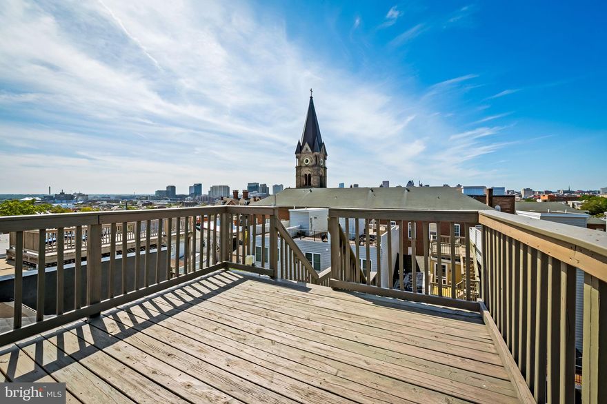 This beautifully renovated 4-bedroom, 3.5-bath townhome offers 2,400 finished SQFT with stunning city and water views from the rooftop deck. The open floor plan features hardwood floors, an updated kitchen with granite countertops and stainless steel appliances, and spa-like bathrooms. Dual-zoned HVAC ensures year-round comfort. The walkout lower level has two bedrooms and an unfinished sub-basement is ideal for storage or a wine cellar. With private street access, the lower level could be converted into an in-law suite or separate unit. Steps from Johns Hopkins, shops, restaurants, and the waterfront, this home blends luxury and convenience.