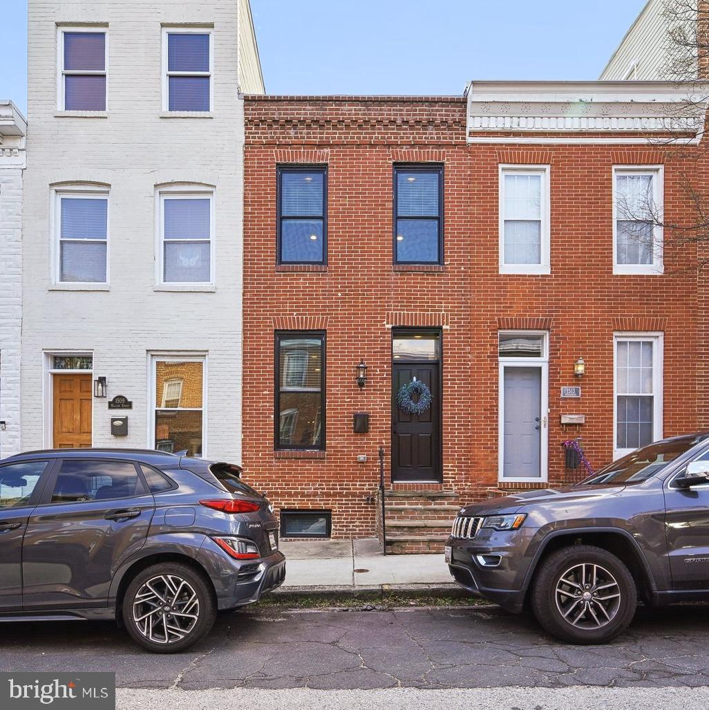 Renovated by Building Character in 2020, this three-level Riverside townhome offers a smart layout, durable finishes, and everyday functionality suited to modern city living. The main level features hardwood floors throughout the living, dining, and kitchen spaces. The kitchen includes stainless steel appliances, a gas range, granite countertops, an oversized island, and a custom tile backsplash.
Upstairs, you’ll find two bedrooms, two full bathrooms, a high-efficiency washer/dryer, and direct access to a private rooftop deck. The primary suite features a walk-in closet and a well-appointed en suite bath with a granite dual vanity, tiled walk-in shower, dual fixed shower heads—including a rain head—and separate temperature controls. All three bathrooms are finished with granite counters, modern lighting, tile throughout, and exhaust fans for added comfort and ventilation. The lower level offers a carpeted bonus room and full bath—ideal for entertaining, a home office, or media space.
Out back, a private patio includes a covered grilling area and space for seating. A full-width parking pad offers off-street convenience via a wide alley.
Located on a tree-lined residential block with local businesses nearby, the home sits near Riverside Park and minutes from Federal Hill, Cross Street Market, Southside Shopping Center, and the stadium district. Easy access to I-95, 295, and other major routes enhances daily commute flexibility. Approximately 5.5 years remain on the CHAP tax credit, offering meaningful savings.