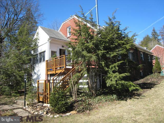 Located in the State College Borough, this home is in a friendly neighborhood just blocks from downtown and PSU campus. Wooded neighboring lot offers ample privacy. Charm and character throughout, the house features hardwood floors, generous living/dining room with extraordinary natural light & views, and a gracious second floor private ensuite master bedroom. Modern kitchen with tile back-splash and breakfast nook. Newly remodeled first floor bath and updated light fixtures throughout. Two enclosed porches (front and back), deck and paver patio courtyard with pergola between home and 2 car detached garage enhance the enjoyment of this home. Alley access to garage and off-street parking. Features include: cedar closet, custom blinds & skylights.