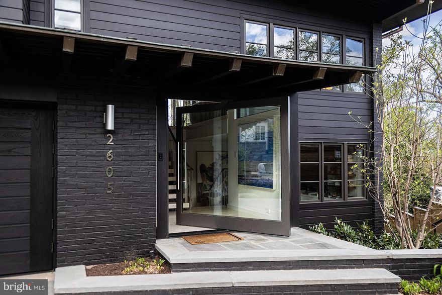 This meticulously reimagined mid-century modern residence, designed by acclaimed architect Wouter Boer, effortlessly merges timeless style with understated luxury. Nestled on a serene cul-de-sac in the heart of Massachusetts Avenue Heights, this modern gem offers an oasis of sophistication.

Upon entry, a dramatic foyer and floating staircase set a stunning tone, leading to an expansive, light-filled living space above. California's relaxed elegance merges seamlessly with DC’s refined ambiance, as floor-to-ceiling windows and doors frame breathtaking views and open to a sprawling deck—ideal for al fresco gatherings.

The chef’s kitchen is a culinary haven, featuring top-of-the-line appliances, custom walnut cabinetry, and generous space for entertaining. Spanning over 5,500 square feet, the home includes five spacious bedrooms and four-and-a-half baths, offering a perfect balance of room for work, relaxation, and rejuvenation. The luxurious primary suite is a sanctuary of tranquility, boasting ample closets, a spa-inspired bathroom with Waterworks fixtures, a rejuvenating steam shower, and a spa bathtub. Additional highlights include a fully-equipped gym, sauna, and much more, showcasing an impeccable level of detail throughout.

Set in a picturesque neighborhood known for winding streets, elegant homes, and scenic city views, this chic residence is just minutes from downtown—a rare fusion of luxury and convenience. Easy to show by appointment.