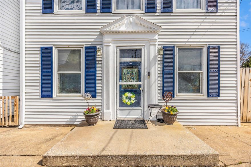 Welcome to 2 North 2nd St in Woodsboro! Historic character and small town charm meet everyday convenience at this lovingly maintained home. The location offers quick access to commuter routes including Route 26, Route 15, and Route 70, making it an easy drive to Wegmans, Super Walmart, and downtown Frederick while enjoying the comfort of a small town setting. The inviting front living area is filled with natural light and highlighted by dramatic decorative ceiling panels and fresh luxury vinyl plank flooring. The kitchen features Corian countertops, 42 inch wood cabinetry, an island and generous storage with direct access to the covered porch and fenced outdoor space. Just beyond is a comfortable gathering room with hardwood floors, wood fireplace and a recently updated half bath. A spacious rear recreation room provides excellent flexibility for a home office, fitness area, or additional living space. Upstairs you will find three well appointed bedrooms including one with a private en suite bath featuring an updated tile shower and fixtures. The primary suite includes a large walk in closet and direct access to the covered second story porch. A spacious laundry room with additional storage is conveniently located on the bedroom level. Outside, enjoy your private oasis with a fully fenced yard, koi pond, a separate summer kitchen that works well for storage or hobbies, and an attached garage with private driveway parking, a rare convenience for homes near the center of town. Recent improvements include a new furnace, new oil tank, and updated electrical service and panels. Enjoy walkable access to local schools, restaurants and Woodsboro park where you can take advantage of playgrounds, trails, and year round community events. Homes with this level of historic character and convenient location rarely become available. Schedule your tour today.