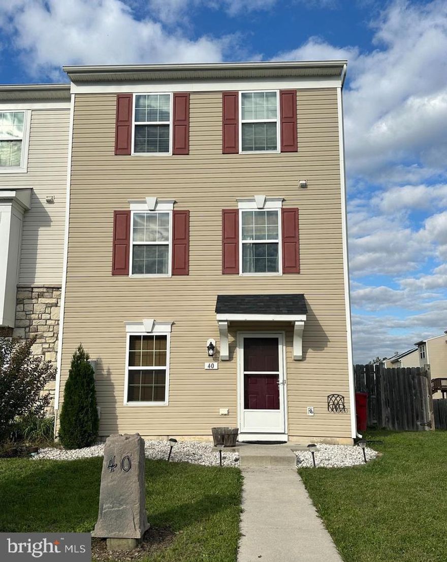 Welcome to 40 Private Ct., a well-appointed and conveniently located townhome—perfect for commuters and shoppers alike! Enter through the ground-level foyer into a spacious finished area, with access to an unfinished section ideal for storage or a workshop, leading directly to the fully fenced backyard. The main level features a bright and airy living room, a half bath, a cozy breakfast nook, and a well-equipped kitchen with a center island. Durable laminate flooring runs throughout most of the home, while the bathrooms are finished with ceramic tile. Upstairs, the third floor offers two bedrooms that share a full bath, as well as a spacious primary suite featuring a walk-in closet, soaking tub, and separate shower.  Step outside to enjoy a private backyard retreat with a charming patio—perfect for relaxing or entertaining. The home includes two designated parking spaces and generous guest parking nearby. Surrounding grassy common areas offer plenty of room for outdoor activities. Located just minutes from Inwood, Winchester, and Charles Town, this property blends comfort and convenience.