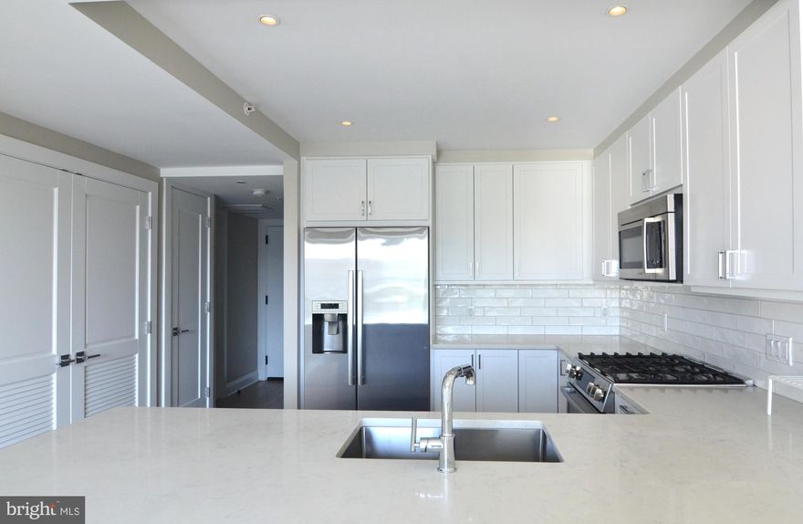 Elegant and charming one bedroom + den at the luxury VENUE condominium in Old Town Alexandria. Built in 2022, this attractive and smartly designed floor-plan optimizes space and flow so it appears larger than the actual 750 sq ft size. A stylish and spacious modern kitchen with white cabinetry, beautiful backsplash, Bosch appliances and large peninsula countertop offers the ideal room for cooking enjoyment. A built-in closet system also supports a well-organized lifestyle. A den with a sliding barn door and custom-built bookcase also offers an ideal flex space for use as a home office, guest bedroom or exercise room. At the VENUE, advantageous amenities, convenient living, delicious eating and adventure await! A full-service concierge and building manager are on-site to support residents’ everyday needs and great restaurants and shopping are close by. Have fitness goals? Make the most of the building’s state-of-the-art fitness center, step right outside for easy access to the Mount Vernon Trail, and store your bike in the bike room. Public tennis courts are also just across the street. Enjoy entertaining? Host guests at the building’s Rooftop Terrace with its outdoor grilling station and fire pit seating area or at the Owner’s Sky Lounge equipped with a fireplace, cocktail bar and flat-screen TVs. The building is also LEED Certified supporting greater energy efficiency. This amazing one bedroom + den is MUST-SEE and immediate occupancy is available. Make an appointment today to visit your stunning future home.