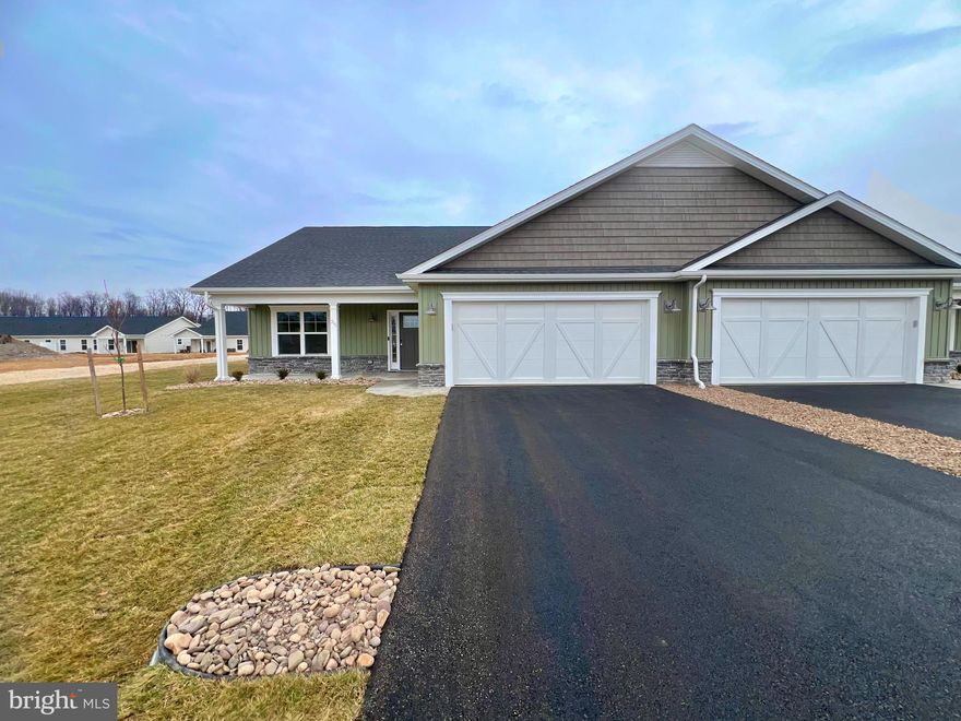 **SIMILAR PICTURES BUT THIS HOME HAS DIFFERENT COLORS INSIDE AND OUT **
ALMOST ready to move in!  This brand-new villa built by Panhandle Homes of Berkeley County has everything you need all on one floor.  Located near the Spring Mills area, Cardinal Pointe is convenient to I-81 for easy access to everything in Berkeley County plus MD/VA.  This home comes finished with an upgraded 12x12 covered rear porch, large covered front porch, 2 car garage with additional storage and a professionally sodded and landscaped low maintenance yard!  Plush carpet in the bedrooms and 100% Waterproof LVP Flooring throughout all the main living areas making cleaning a breeze.  Soft close cabinets in the kitchen and bathrooms! The owner's suite has a large step in shower, dual bowl vanity and comfort height commodes.  Common area and a berm behind this home gives you extra privacy.  Schedule your appointment to tour this home today!