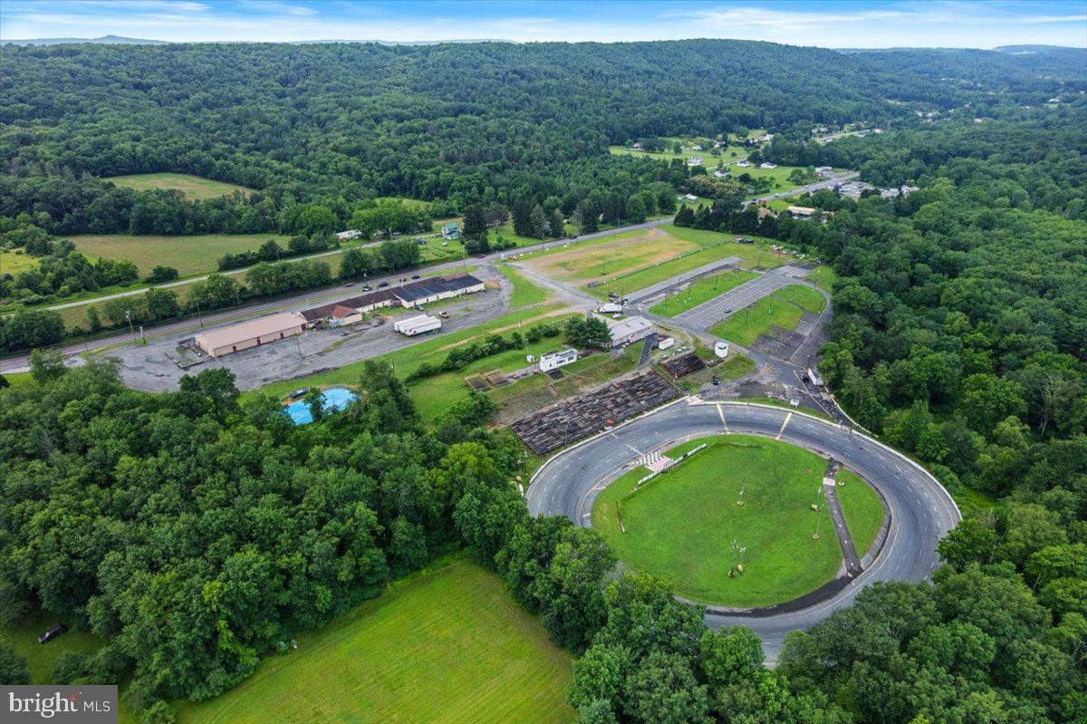 Introducing a prime 30-acre commercial property in Lehighton, PA—currently operating as the Mahoning Valley Speedway—offering unmatched visibility, access, and development potential. Zoned C-1 Commercial, this property sits in a thriving corridor surrounded by major anchors such as Lehigh Valley Hospital, Lowe’s, and Walmart, ensuring consistent traffic and strong consumer demand. With approximately 1,500 feet of direct road frontage along Route 443, the site features three approved highway access points, providing exceptional ingress and egress, and enhancing its appeal for high-traffic commercial use.
The C-1 zoning allows for a wide variety of commercial applications, making this an ideal opportunity for developers, investors, or end users looking to establish anything from retail centers and medical complexes to entertainment venues, industrial operations, or automotive-related facilities. The existing speedway presents a unique value-add—whether repurposed for events, adapted into a recreational feature, or reimagined entirely, it offers built-in infrastructure with immediate utility. For those looking to continue in motorsports, maintaining the site as a functioning speedway is a viable option with an established brand and regional following already in place.
The expansive acreage supports significant build-out potential, including large-scale structures, ample parking, and long-term expansion. As Lehighton continues to grow, this property stands out as a strategic, high-visibility location with the flexibility and footprint to suit a wide range of commercial ventures. Owner financing is available, adding further appeal and accessibility for qualified buyers. Opportunities like this—offering size, exposure, existing infrastructure, and versatile zoning in a rapidly developing market—are increasingly rare.