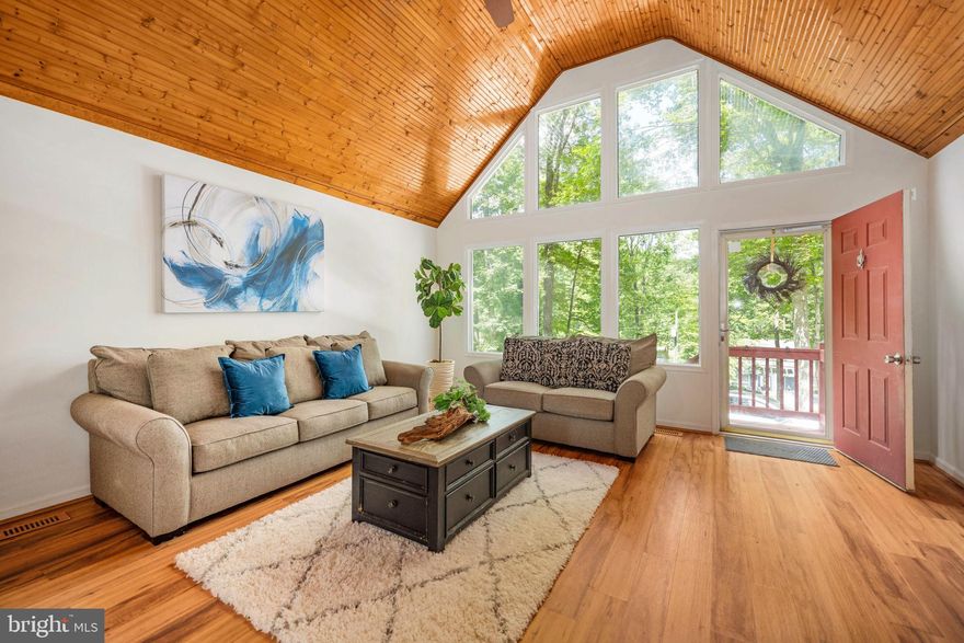 Effortless One-Level Living in Amenity-Filled Lake of the Woods!  UNIQUELY BEAUTIFUL HOME -- one of a kind!

Discover comfort, style, and convenience in this beautifully maintained 3-bedroom, 2-full bath rambler tucked inside the gates of the sought-after Lake of the Woods community. Whether you're seeking a weekend retreat or a full-time home, this one delivers.

Set on an elevated lot with mature trees, this home welcomes you with extra parking alongside the driveway and an attached garage.  Out back, enjoy a large deck perfect for entertaining or simply taking in the peaceful surroundings.  Concrete slab and electrical make this home jacuzzi-ready! 

Step inside to find gorgeous wood-planked vaulted ceilings and sun-filled windows that bathe the space in natural light. The open-concept layout blends the family room, dining area, and kitchen, making it ideal for both daily living and gathering with friends and family. The kitchen boasts modern cabinetry, stainless steel appliances, and a smart design for efficiency and flow.  The laundry area is conveniently located off the kitchen.  All three LARGE bedrooms feature low-maintenance LVP flooring, and the primary suite includes a remodeled shower and private bath.   Master bedroom can accommodate a king-size bedroom set.  And the raised crawlspace offers extra room for storing lawn equipment, tools, or seasonal gear.

As a resident of Lake of the Woods, you’ll enjoy a lifestyle rich with recreation and relaxation—featuring two private lakes for boating, kayaking, and fishing, an award-winning golf course, beaches, a community swimming pool, tennis courts, equestrian stables with riding trails, sports fields, tot lots, and a marina with boat ramps. The neighborhood also includes 24/7 gated security, scenic walking trails, and a vibrant calendar of year-round social events and activities for all ages.

This charming home offers peaceful living, practical features, and unbeatable access to the best of Lake of the Woods. Don’t miss the chance to make it yours!