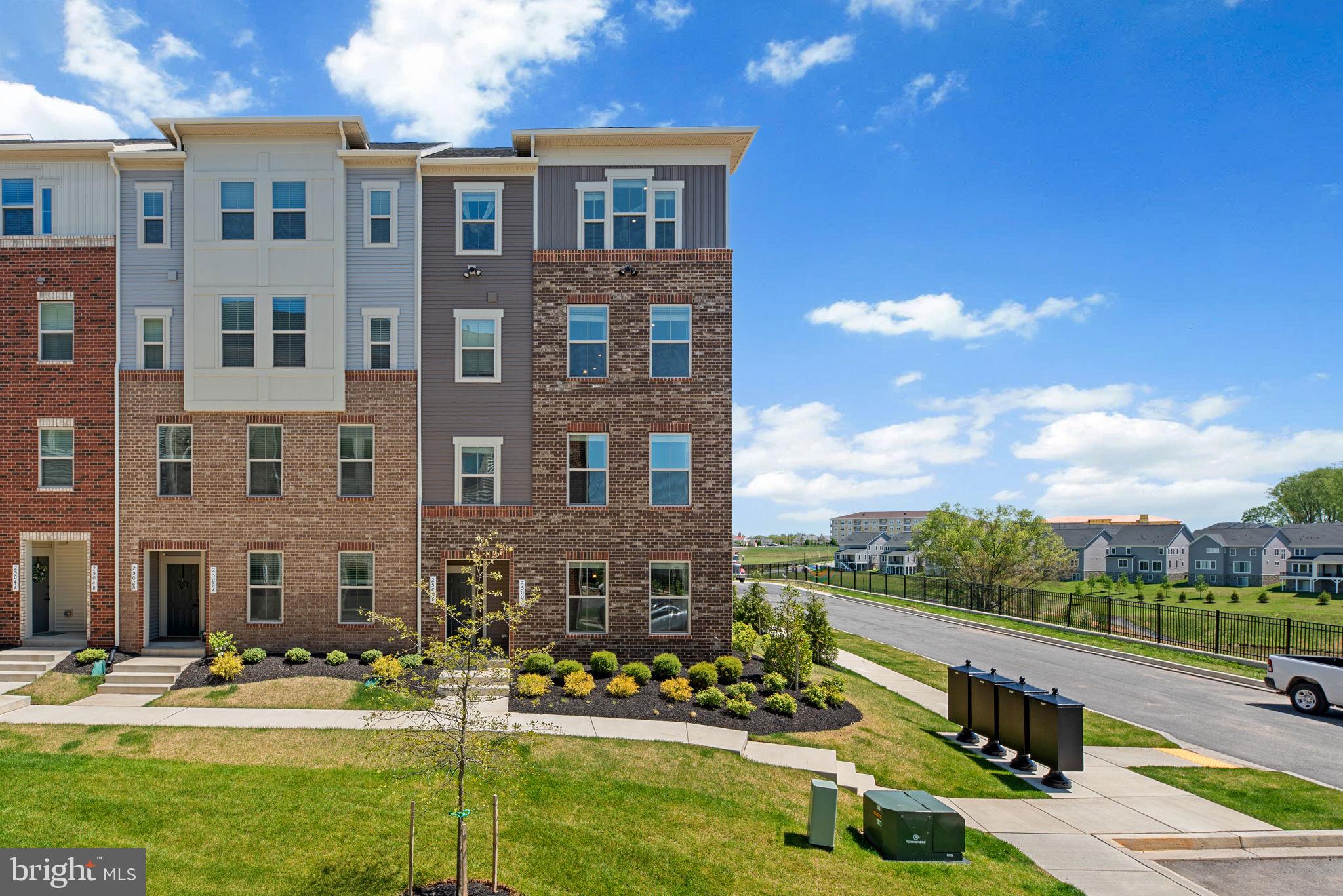 Available for rent, this stylish end-unit condominium in the desirable Town Square Row community was newly built in 2024 and offers 1,747 square feet of modern living space. With 3 bedrooms, 2 full baths, 1 half bath, and a 1-car garage, this home combines comfort and convenience in a thoughtfully designed layout. The main level features a welcoming powder room, a spacious great room with a dining area enhanced by sleek laminate plank flooring and recessed lighting. The bright white eat-in kitchen is both functional and beautiful, showcasing quartz countertops, a subway tile backsplash, stainless steel appliances including a gas range, pendant lighting, a breakfast bar, and a pantry. Upstairs, you’ll find three carpeted bedrooms and two full bathrooms, along with a laundry room complete with a utility sink. The expansive primary suite includes two walk-in closets and a private en suite bathroom with double sinks. The third bedroom offers the added bonus of a private balcony—perfect for enjoying a morning coffee or evening breeze. A landscaped side yard provides additional outdoor space.