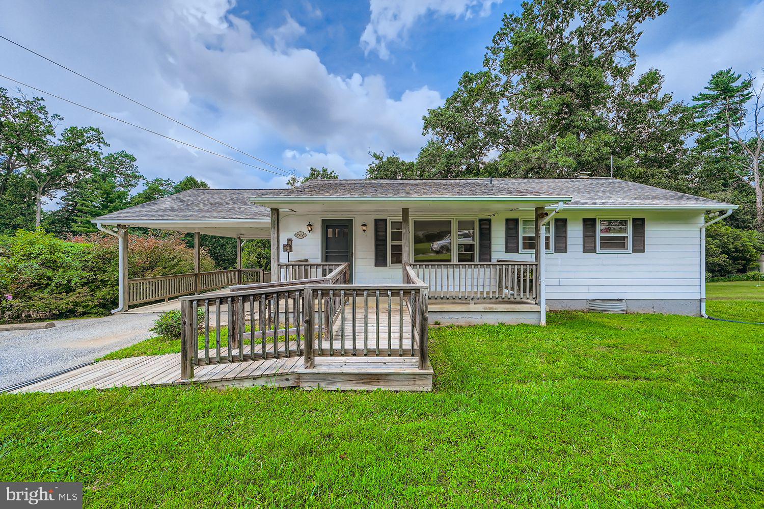 Welcome to this charming 3 bed 2 full bath ranch-style home in the heart of sykesville offering a versatile layout, plenty of natural light, and a spacious yard backing to trees.
The main level features hardwood floors throughout, a spacious kitchen with plenty of cabinet storage and room for dining, and a living room with a large bay window that fills the space with natural light. The home also features three bedrooms and two full baths giving you a practical and comfortable layout.
The lower level adds extra living space with a family room with wood stove and a walk out to the covered rear porch, along with a utility area and storage room.
Outside, enjoy a covered front porch, a large carport, and an expansive covered patio out back—perfect for outdoor living in every season. The property also features a level backyard with mature trees, offering privacy and plenty of space to play, garden, or simply unwind.
With its functional layout, ample storage, and peaceful setting, this home is ready for you to make it your own. Updates include a brand-new roof (2025) and updates to the septic system (2024).