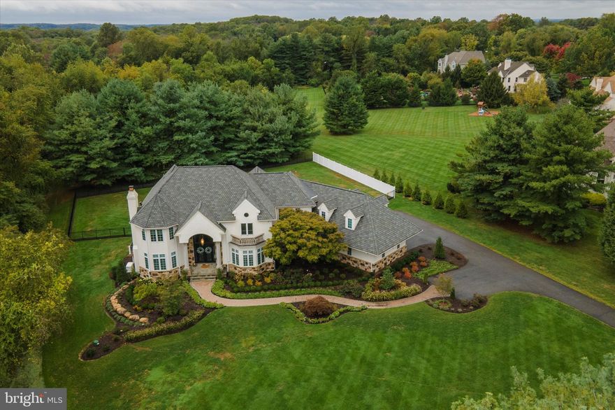 This magnificent 6-bedroom manor is tucked away on a private, 3.5-acre lot in the Fawn Run community of Chaddsford Twp. Enjoy the peace and quiet of this tranquil setting while having countless amenities at your fingertips. Close to the quaint downtown, cultural attractions, Longwood Gardens, the Brandywine Museum of Art and the Battefield Park, Unionville/Chaddsford schools, Baltimore Pike is a mile away and only 30 mins to the airport. Chaddsford and Penns Woods Winery, fantastic dining options and Wegmans/Whole Foods are nearby. Not to mention, just a short drive to tax free shopping in DE. No stone went unturned when it came to completely transforming this property. The current homeowners not only picked top-of-the-line cosmetic finishes, they also made sure to maximize the functionality of the home. From the moment you pull up to the 3-car garage, you will be impressed with the meticulously maintained grounds including all new landscaping and a fully fenced-in backyard. Talk about a grand entrance! The custom double door entry leads into the two-story foyer featuring an imperial staircase with custom wrought iron railings and luxurious porcelain tile flooring. The formal living room with a wood-burning fireplace, wet bar and private deck sits directly to the left of the entry way, and the glamorous formal dining room sits to the right. Continue into the stunning chefs kitchen featuring solid-wood cabinetry, marble countertops, Meile appliances, a separate breakfast room surrounded by windows and a large breakfast bar. There is a walk-in pantry for all your dry goods and a separate butlers pantry, ideal to use as a coffee or wine bar. Sitting adjacent to the kitchen is the jaw-dropping great room which received a tremendous upgrade. Decorative woodworking continues up the wall to the open second floor balcony. A floor-to-ceiling wood burning fireplace with a precast limestone surround is the focal point of the room. Two skylights allow sunlight to stream inside. A first-floor bedroom suite is conveniently located with a private full bathroom. Finishing up the main floor are two powder rooms and a large laundry room located adjacent to the garage entrance. After a tiring day, kick back and relax in the gorgeous primary suite. Hardwood floors pop against the white walls, decorative wood paneling and the white vaulted ceiling. A gas fireplace provides a nice ambiance. A dressing room separates the bedroom from two walk-in closets and the incredible en suite bath. The custom tile work on the bathroom walls is truly a work of art. A large walk-in shower sits beside the dual sink vanity. Tucked away in its own separate alcove sits the free-standing soaking tub, providing private views of the backyard. Three additional bedrooms are located on this level, as well as two additional full baths. A walk-in closet room was created on this floor and includes a custom- built-in vanity. If desired, this room can be turned back into a 5th bedroom. The third story was newly created by adding another staircase and finished as a spectacular walk-in closet. Those with an extensive handbag and shoe collection will truly appreciate this private space (keypad entry protected and climate controlled). The custom built-ins for shoes, handbags and gowns is expertly laid-out to feature max storage. A faux-rose wall provides a pop of color in the otherwise neutral room. This will certainly be a favorite! The finished basement has been nicely upgraded and was built for those who appreciate entertaining. The custom bar a porcelain herringbone tile which continues into the game room. Cozy up in the beautiful theater room to enjoy your favorite movie or TV show. For those who enjoy working out, no need to head to the gym when you have your own private fitness room. An elegant full bath is conveniently located just steps away from the basement entry. New 4-zone HVAC system, new water heaters, back-up generator and new 320 amp electric.