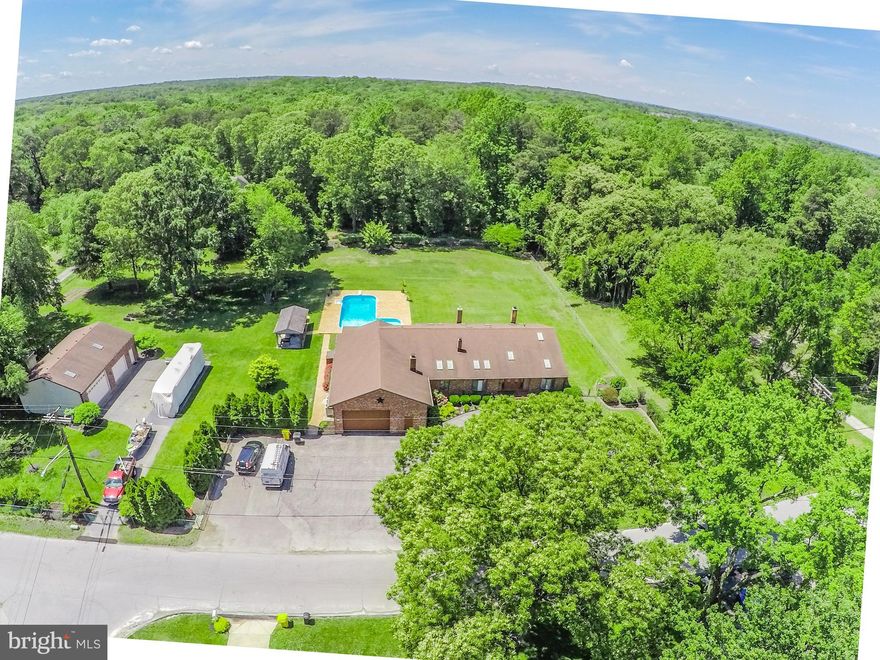 Beautifully updated rancher in the highly sought after Brookfield community. This 3 bed 3 bath home sits on a nicely landscaped 1.76 acre lot that is just 3 blocks from the Magothy River. The lot has an in-ground saltwater pool, picnic pavilion and a 3 car detached garage with separate office space, plenty of room for any project! Inside you are welcomed with tons of natural light featuring 13 skylights through the home. Additionally you find a bonus family room behind the attached 2 car garage that could easily be converted to another master bedroom or in-law suite. Upgrades include tiger wood hardwoods, granite counter-tops, stainless steel appliances heated flooring, tankless water heater, dual zoned HVAC, water filtration system, and much more. Truly a one of a kind home for the area, set up a showing today! Contact us for a list of all upgrades.