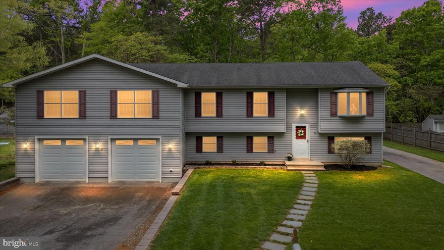 Tucked away on a quiet dead-end street in sought-after water privileged community of Boulevard Park, this expansive home offers over 3,500 square feet of comfortable living space surrounded by peaceful wooded views. With two separate driveways, including dedicated space for an RV or boat, this property provides everyday convenience with rare flexibility. Inside, natural light pours into the spacious living room through a large bay window, creating a bright and inviting atmosphere. The thoughtfully designed layout continues into a well-appointed kitchen with stainless steel appliances and a separate dining room with updated chandelier.  The main level also features gleaming hardwood flooring. The sprawling 29'x19' primary suite complete with its own office/nursery room, spacious sitting area, two oversized walk-in closets, an electric fireplace, and a private en-suite bathroom with jetted tub, tile-surround shower and dual vanity. Two additional bedrooms and a second full bathroom provide comfortable accommodation for family or guests. The rear sliding glass door opens to a relaxing 11'x18' four-seasons room with vaulted ceiling, recessed lighting and wall-to-wall windows. Outdoor deck area for additional gathering space and grilling.  Downstairs, the finished basement expands your living options with a large 23'x17' family room, a third full bathroom, and a versatile flex space ideal as a fourth bedroom, home office, or gym. A utility and laundry room adds functionality, while direct access to the oversized 29'x29' two-car garage enhances everyday ease. With its large & flat backyard, the property is set against a backdrop of mature trees. This home offers the space, privacy, and versatility that you are looking for. Chesapeake Schools District! Schedule your showing before it's too late!