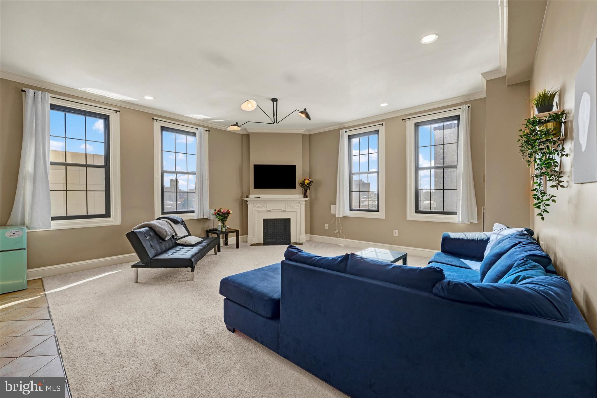 Welcome to condo #403 in The Belvedere, a beautiful and historic building centrally located near restaurants and attractions in Mount Vernon. This spacious 1200SF, 2 bedroom, 2 full bathroom corner unit boasts breathtaking city views, large windows providing ample natural light, and high ceilings that create an open atmosphere. The living room is sizable, offering space for a dining table, chairs, and plenty of seating for relaxation and entertaining. The kitchen is equipped with modern appliances and stone countertops, and overlooks the living area. The primary bedroom is generously sized, featuring two closets and an en suite full bathroom. The second bedroom is substantial and positioned directly across the hall from the second full bathroom. Residents of The Belvedere enjoy on-site 24-hour concierge services, the stunning lobby, and the Owl Bar Restaurant. This unit promises comfort, convenience, and a prime location.