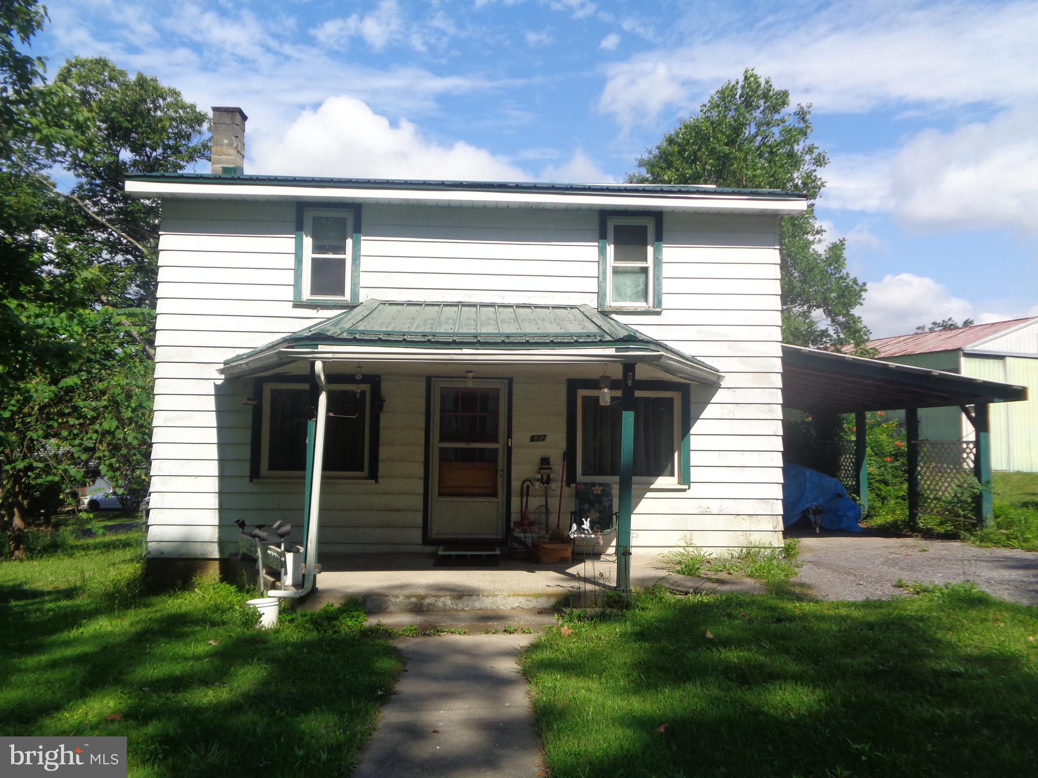 If you'd rather do it yourself, come see this traditional 3 bedrooms, 1 bath, 2 story with attached carport and detached 24' x 40' garage/pole barn. Needs a little loving care but great potential. Not far from town on Jack's Creek Road with lots of room for family and gardening. Updated include new furnace in 2018 and roof in 2022. Call today.