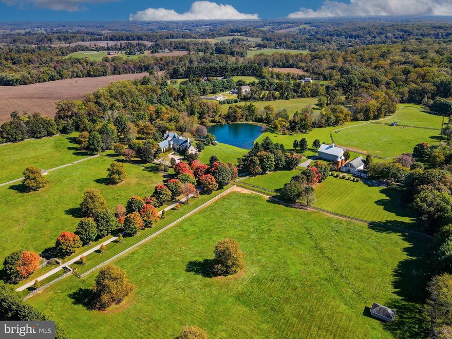 Live authentically. Blissfield… A vision realized. Set upon 54 acres in the heart of Maryland’s legendary horse country. Blissfield is a dazzling architectural masterpiece. Born of a resolute appreciation of form, scale and intrinsic quality, the entire estate bespeaks reverence for bold vision, artistic creativity, and thoughtful collaboration among different disciplines, which has produced a property of undeniable elan. A creation of indisputable beauty befitting the glorious grounds upon which it sits, Blissfield is both a sanctuary and a triumph. A tree-lined drive leads you to the reveal of an epic glistening pond with an authentic English Manor estate perched just so.

Impeccable finishes abound in both the exterior and interiors. Exterior walls, built of Gettysburg Stone. Custom limestone sills and entrance. Copper standing seam roof, gutters, downspouts, and flashing. Custom, hand-forged iron railings, balcony, gates, and hardware. Hand-crafted cabinetry and paneling of wormy chestnut, vintage pine, satinwood, cherry, English oak and pecan. Flooring of vintage oak, pine, and quarter-sawn travertine marble. Eight Rumford-style fireplaces. Heated flooring. Field-built trusses of vintage hand-hewn beams. Antique marble mantles. Antique French bronze chandeliers. Satinwood lady’s dressing room and distinguished gentleman’s dressing room. Hardscapes of Belgian block and bluestone.

Every room has been designed to reflect a human scale, and to take advantage of glorious vistas. The estate includes light-filled wings, french doors, and casement windows that allow one to connect to the many gardens and terraces. The home includes four-bedroom suites, eight bathrooms, family room, sun room, great room, library, dining room, eat-in kitchen, morning room, two master dressing rooms, mud room with kennels, and elevator. English club-style lower level with wine room, billiards room, and bar. Private office in main house.

The grounds and the home have been designed to complement and take advantage of the stunning views across a two-acre, 12 foot deep, spring-fed, stocked pond. The outbuildings include: a potting shed, equipment shed, and pool pavilion, all with copper roofs. Bank barn, c.1860 with stable with tack room, stalls, and wash-down. Dairy barn, including a second floor apartment with two bedrooms, baths, and a full kitchen, wainscoting, heat, A/C, and fireplace. A guest home with three bedrooms, three full baths, fireplace is also on the grounds. (Barn and other structures currently generate strong rental income.) In-ground heated swimming pool. Twenty acres of fenced paddocks, with run-in sheds and automatic waterer. Two streams and one bridge. Formal English gardens. In-ground automatic sprinkler system. Generator, four generous wells, and natural gas.

Stately and eminently livable, Blissfield beckons. Convenient access to Baltimore and Washington, D.C. One of America’s finest estates. Cultivate your existence. The art of uniting human and home.

Architect: Robert Hollendonner | Interiors: LeVanis Associates, Inc. | Landscape Architect: Stratton Semmes, Annapolis | Builder: GYC Group, Ltd. | Date completed: 1999.