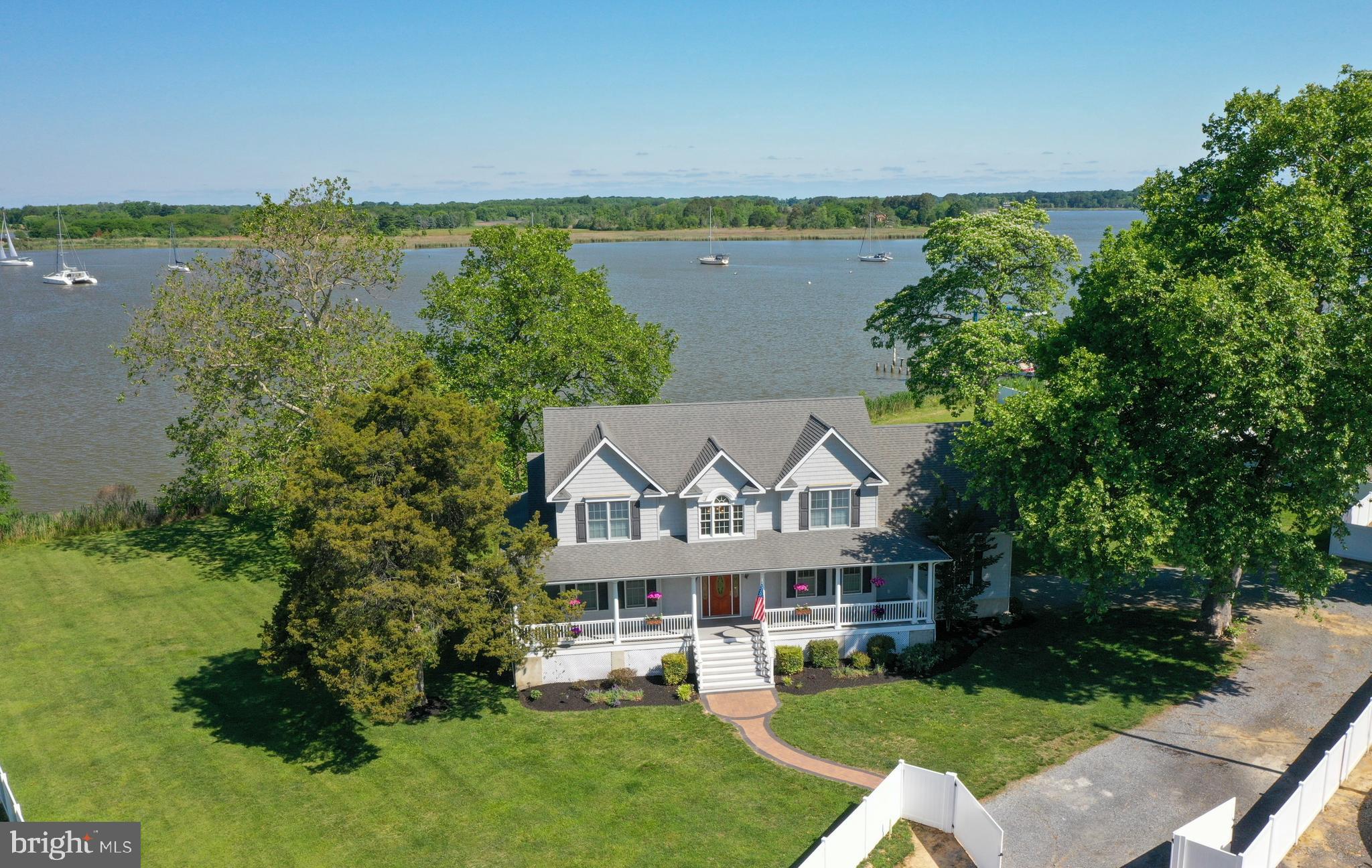 Nestled on the tranquil shores of Swan Creek, this 3,000+/- sq ft waterfront home offers a rare blend of elegance, comfort and Chesapeake charm. Featuring 3-4 bedrooms, 3.5 baths, and a desirable first-floor primary suite, this thoughtfully designed home invites relaxed coastal living. The great room is a showstopper with its dramatic two-story windows and cozy fireplace, framing picture-perfect waterviews of boats gliding by.
Enjoy seamless indoor-outdoor living with a fully fenced yard—ideal for entertaining, gardening, or quiet evenings under the stars. The spacious two-car garage offers ample storage, while your private boat slip just steps away provides effortless access to the water.
Located in a unique land condominium community in the heart of Rock Hall, this home is just minutes from marinas, restaurants, and shops. Whether you're savoring fresh local crabs on the deck or soaking in Swan Creek’s unforgettable sunsets, every day here feels like a getaway. This is Eastern Shore living at its finest.