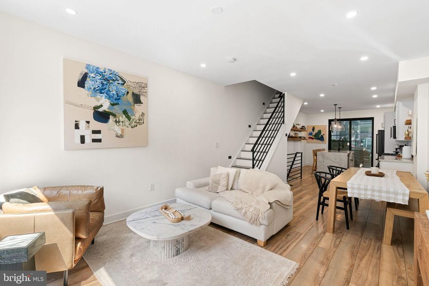 Nestled in the desirable Point Breeze neighborhood, this contemporary townhouse, built in 2021, offers a harmonious blend of modern elegance and comfortable living. With three spacious bedrooms and two and a half luxurious bathrooms, this home is designed for both relaxation and entertaining. As you approach the property, the striking masonry exterior exudes sophistication, while the inviting patio beckons you to enjoy al fresco dining or morning coffee in the fresh air. Ascend to the stunning roof deck, where panoramic views create the perfect backdrop for sunset gatherings or quiet evenings under the stars. Step inside to discover a thoughtfully designed interior that maximizes space and light. The fully finished basement offers additional living space, perfect for a home office, gym, or entertainment area. The main living areas are adorned with high-end finishes, ensuring a seamless flow throughout the home. The heart of this residence is the gourmet kitchen, equipped with top-of-the-line appliances, including a built-in microwave, gas oven/range, and a sleek refrigerator. The dishwasher and disposal make clean-up a breeze, allowing you to spend more time enjoying your culinary creations. The convenience of an upper-floor laundry area adds to the ease of daily living. Each bedroom is a serene retreat, providing ample space for rest and rejuvenation. The bathrooms are designed with luxury in mind, featuring modern fixtures and finishes that elevate your daily routine. The Point Breeze community offers a vibrant lifestyle, with nearby amenities, attractions and Wharton Square Park. Embrace the opportunity to call this stunning residence your home.