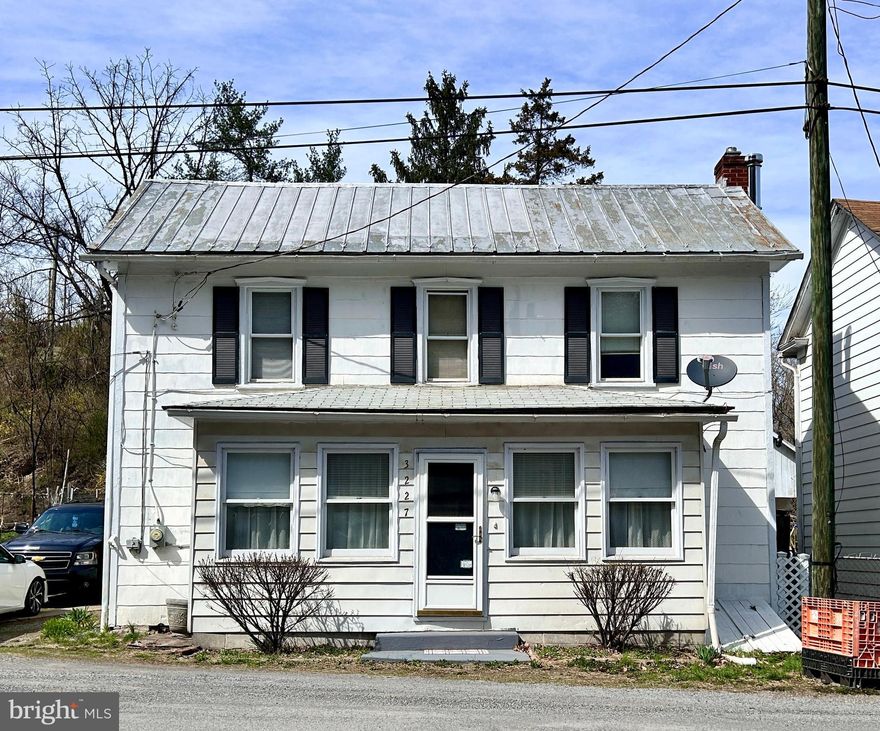 Step into a piece of history with this beautifully semi-restored 1900 farmhouse, a perfect blend of old-world charm and modern convenience.  With over 1,600 square feet, this 3 BR 2 1/2 BA home welcomes you with gorgeous hardwood flooring that runs throughout, adding warmth and character to every room.

Nestled on over 6/10 of an acre of unrestricted land, this property offers endless possibilities—whether you're dreaming of a hobby farm, a homestead, or simply a peaceful retreat. With multiple outbuildings, there’s plenty of space for storage, workshops, creative projects.  There's even an old chicken coop that could be utilized for cost-savings on eggs!  You'll love the oversized 2 car detached garage that offers many possibilities for auto enthusiasts, or for the hobbyist who likes to tinker around with projects.

For water enthusiasts, the location is unbeatable. A short five-minute walk takes you to the majestic Potomac River, where you can fish, swim, kayak, or launch your boat from the nearby boat ramp. Spend your mornings sipping coffee on the porch, your afternoons exploring the water, and your evenings enjoying the tranquility of country living.

The home itself features stainless steel appliances in a well-appointed kitchen, with built-ins, blending modern efficiency with timeless appeal. Whether you're looking for a full-time residence, a vacation getaway, or an investment with incredible potential, this property is a rare gem waiting to be discovered.

Come experience the charm, history, and adventure that await in this farmhouse that's ready for its new owner.  Schedule your showing today!
